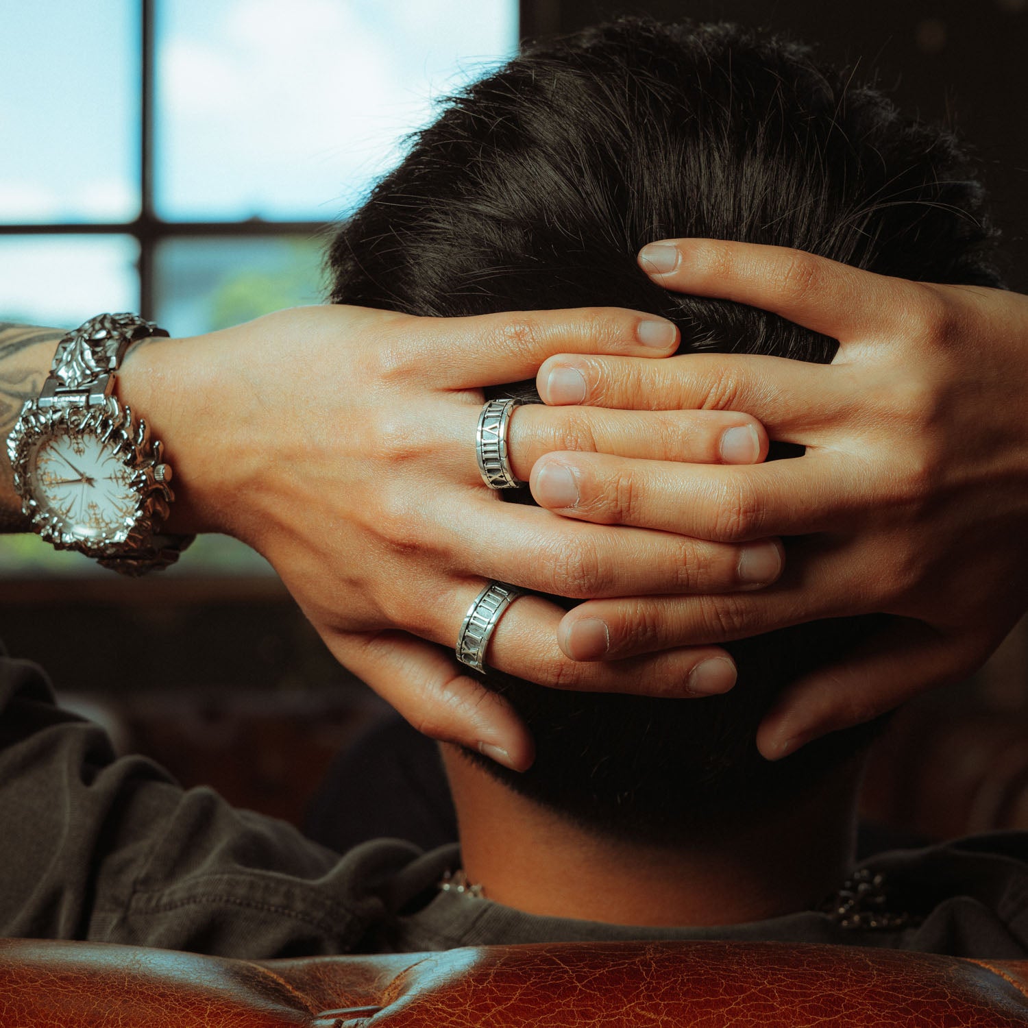 Sterling Silver band rings with roman numerals the entire way around it on male hand