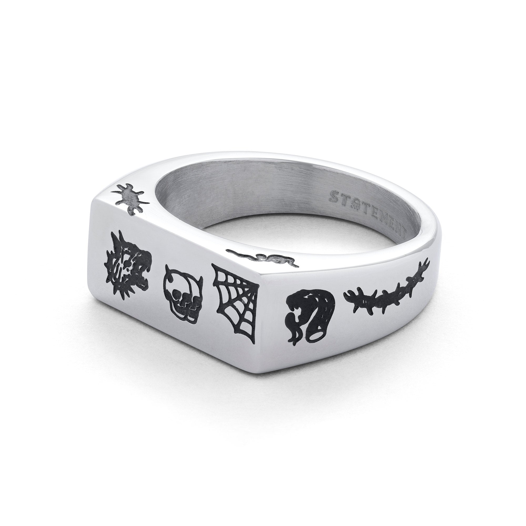 Silver signet ring, rectangular shaped with traditional style tattoo details including skulls, snakes, spider webs, barbed wire on side