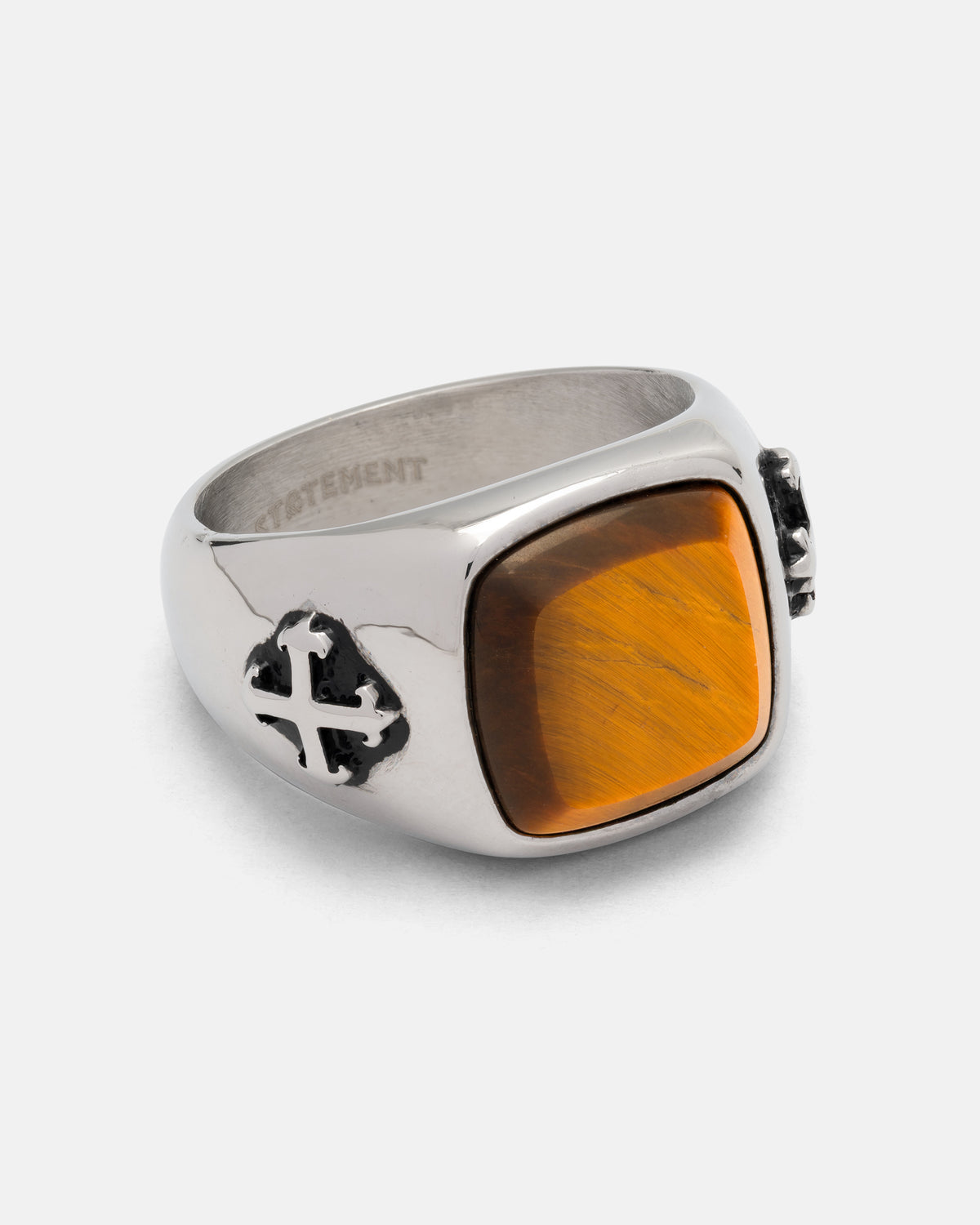 Statement Collective Tigers Eye Stone Ring featuring a stainless steel band, rectangular tigers eye stone, and a cross emblem on the side.