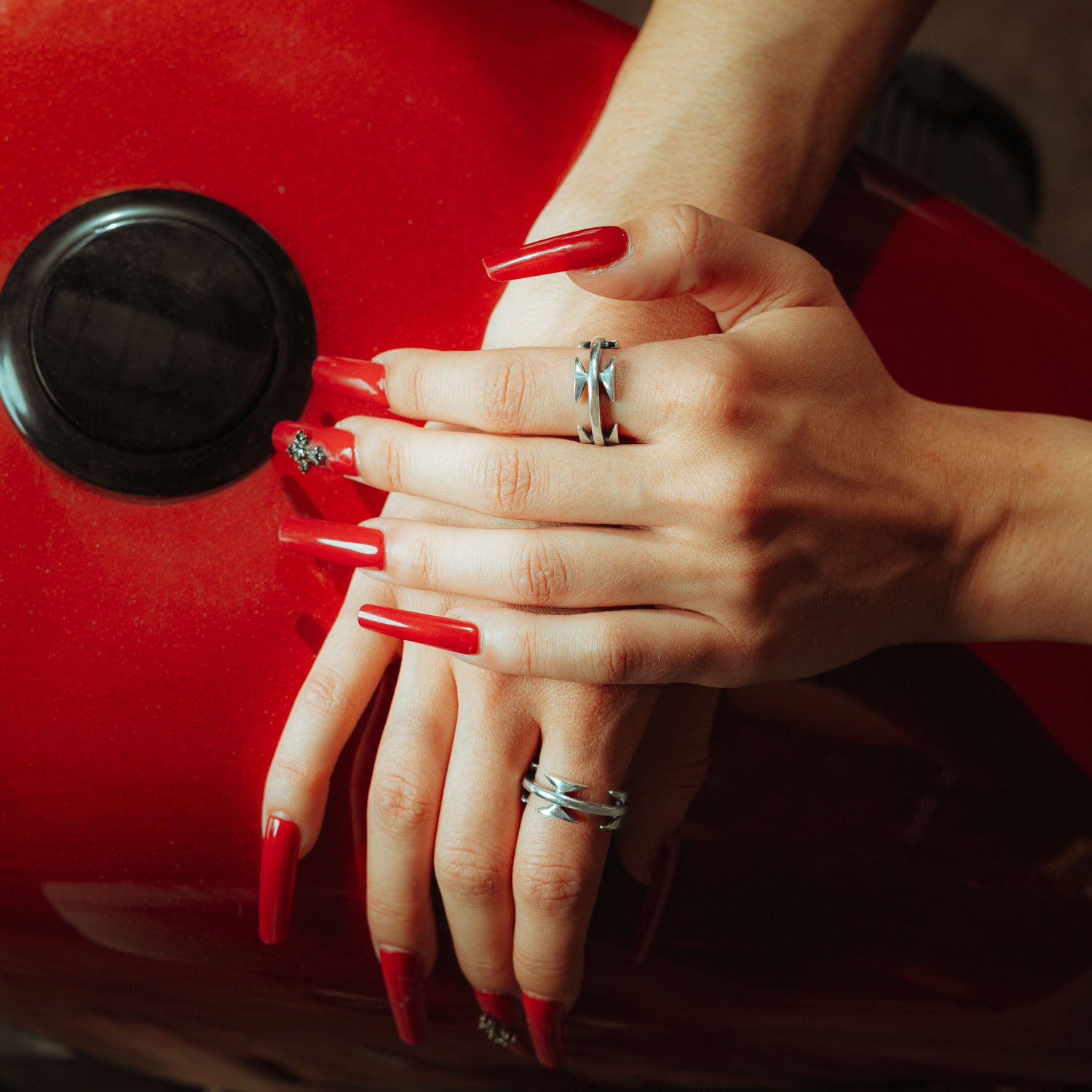 sterling silver razor wire ring on female models hands with red nails