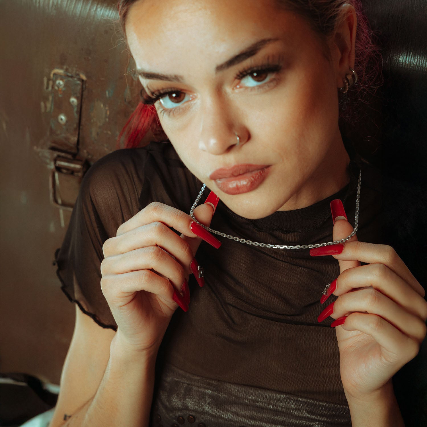 3mm cable chain in sterling silver being held up by female model with red nails