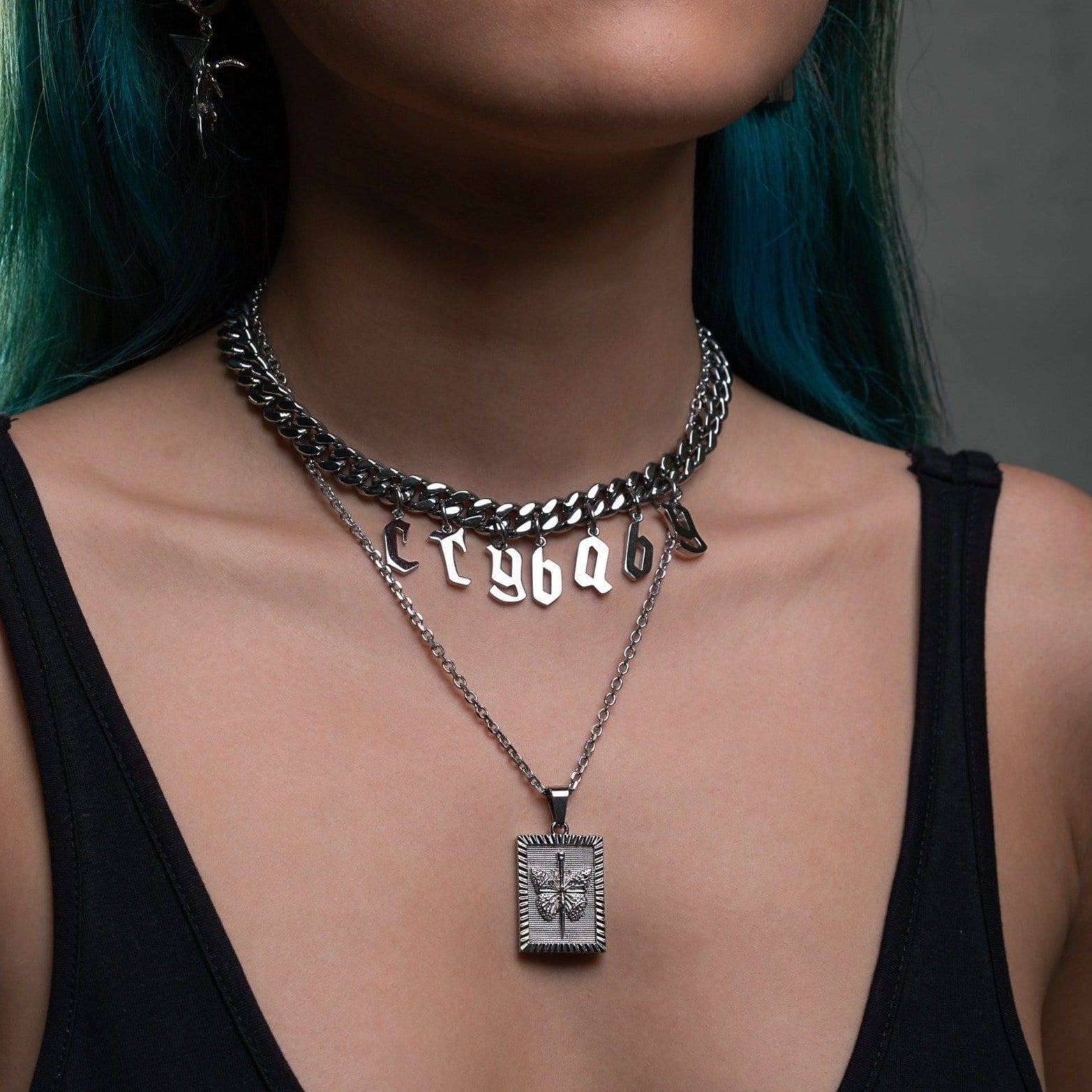 woman's neck with pendant necklace and butterfly design by statement collective