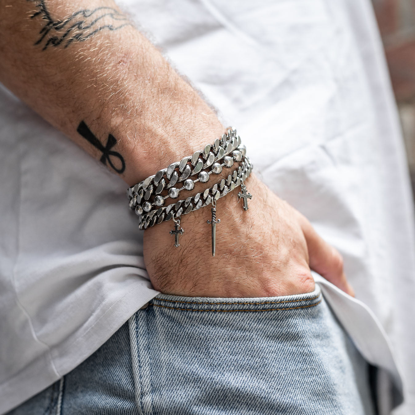 Crusader Cuban Link Bracelet on mens hand stacked with other bracelet by statement