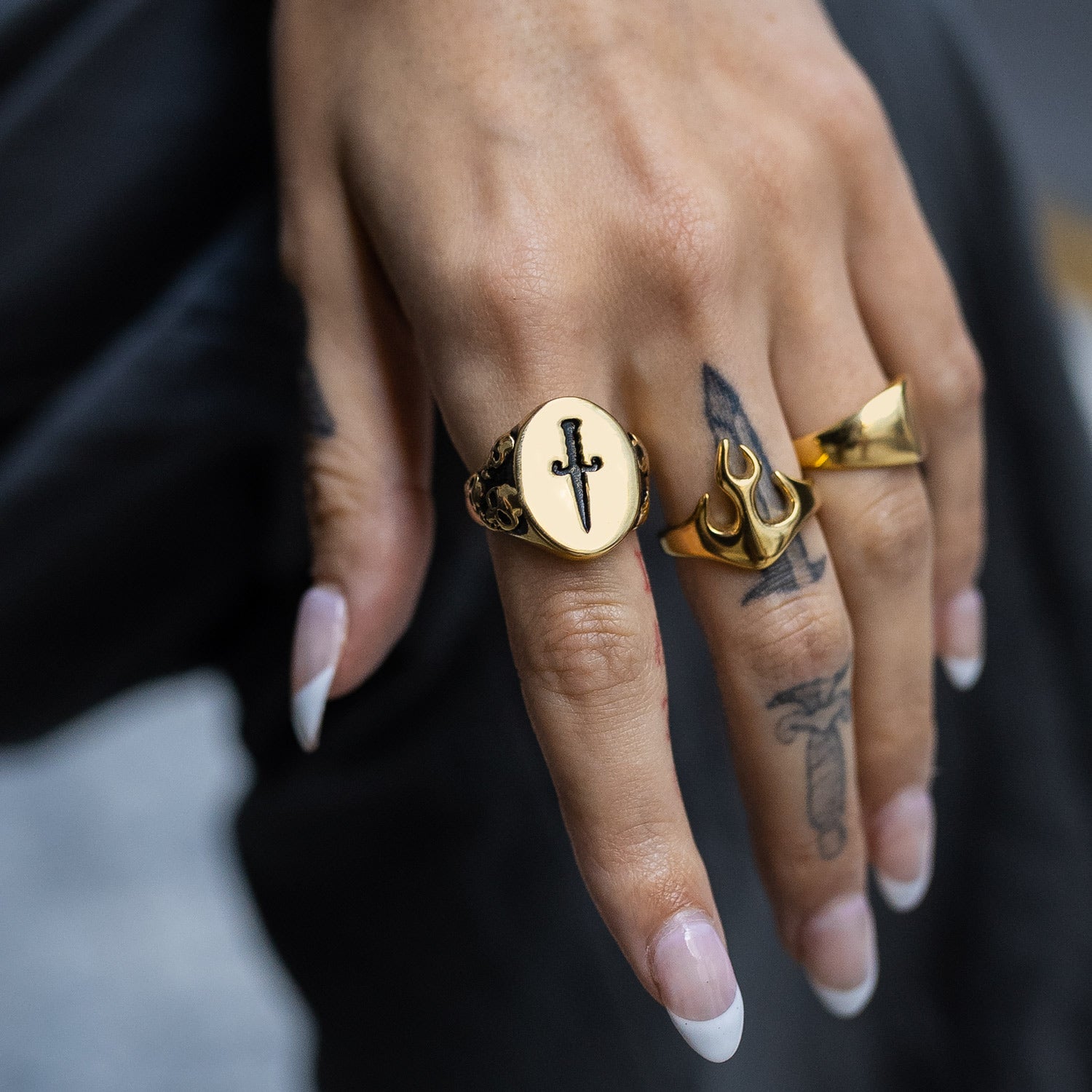 womens dagger and skull signet ring on body