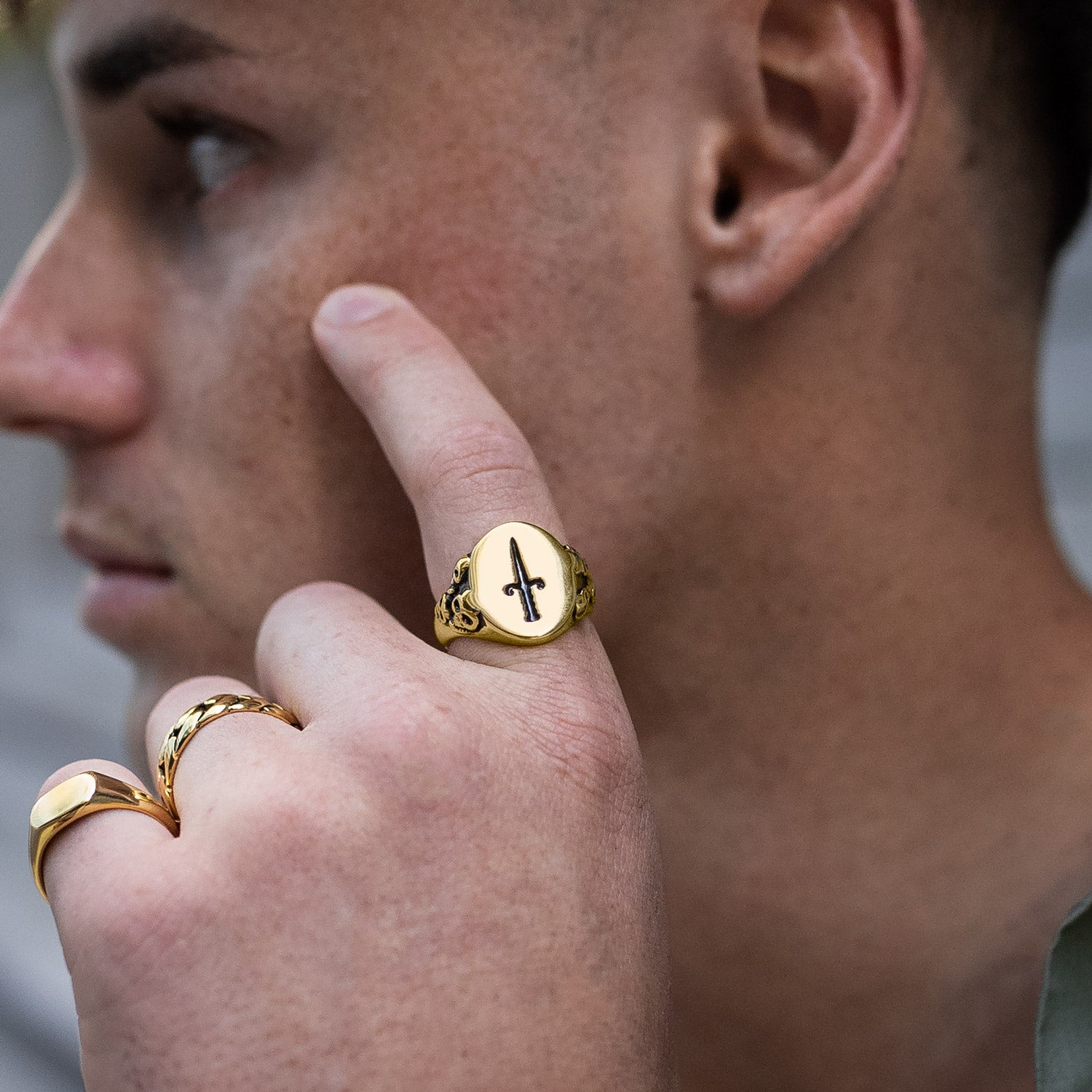 mens gold dagger signet ring on model