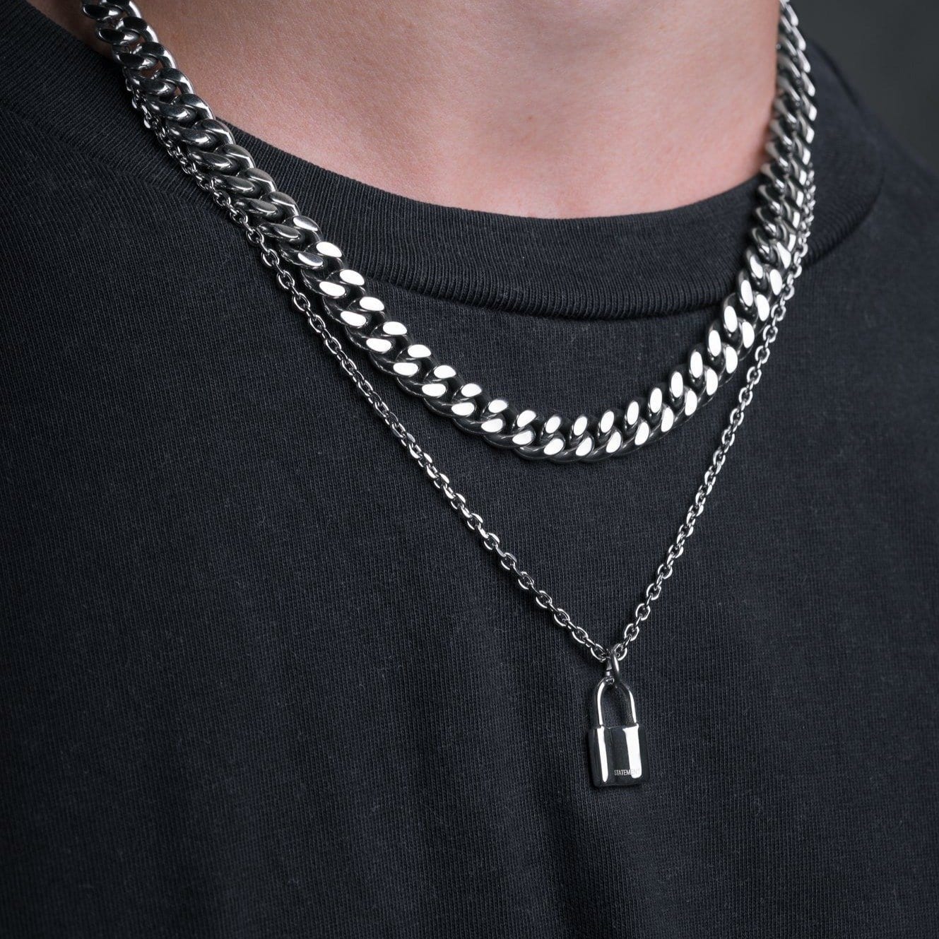 small padlock pendant necklace on men's neck by statement collective