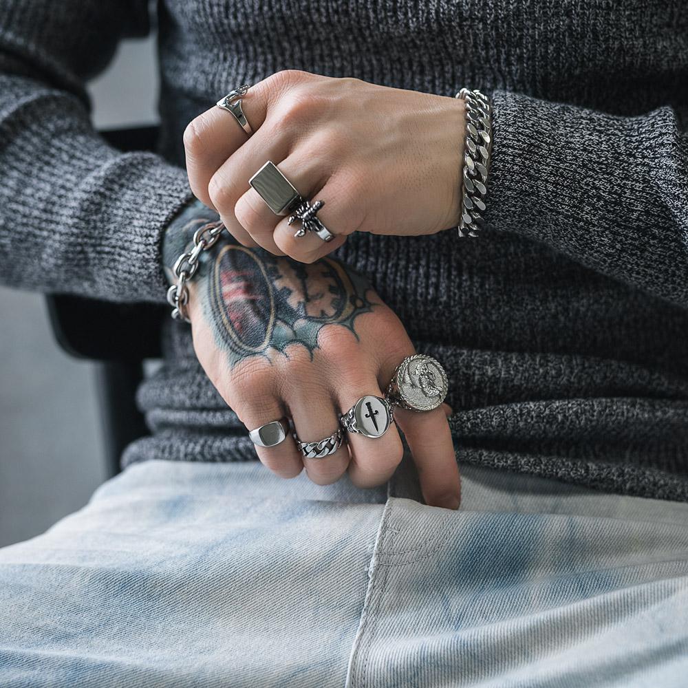 mens hands with silver rings and bracelets by statement collective