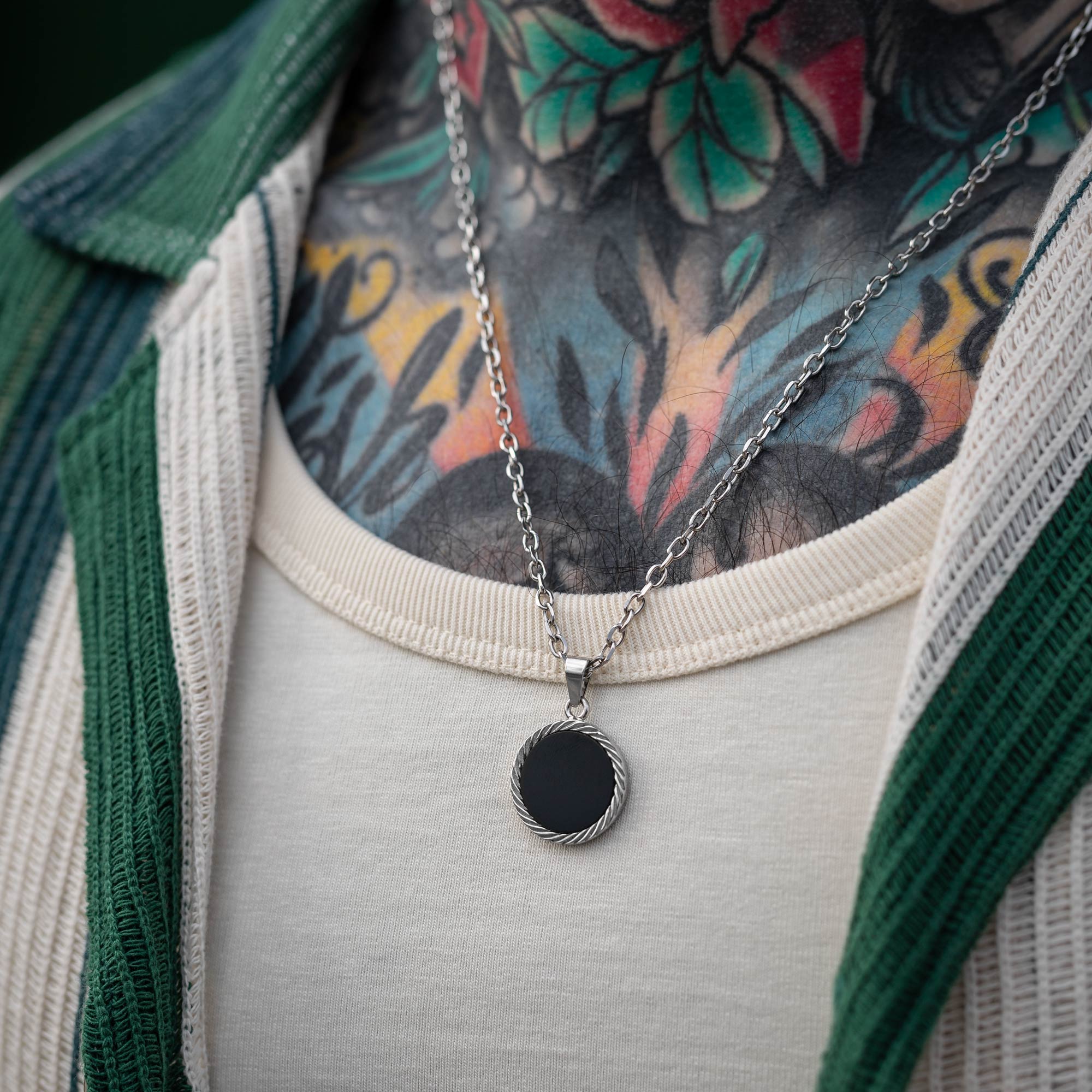 circle medallion with onyx gemstone on body