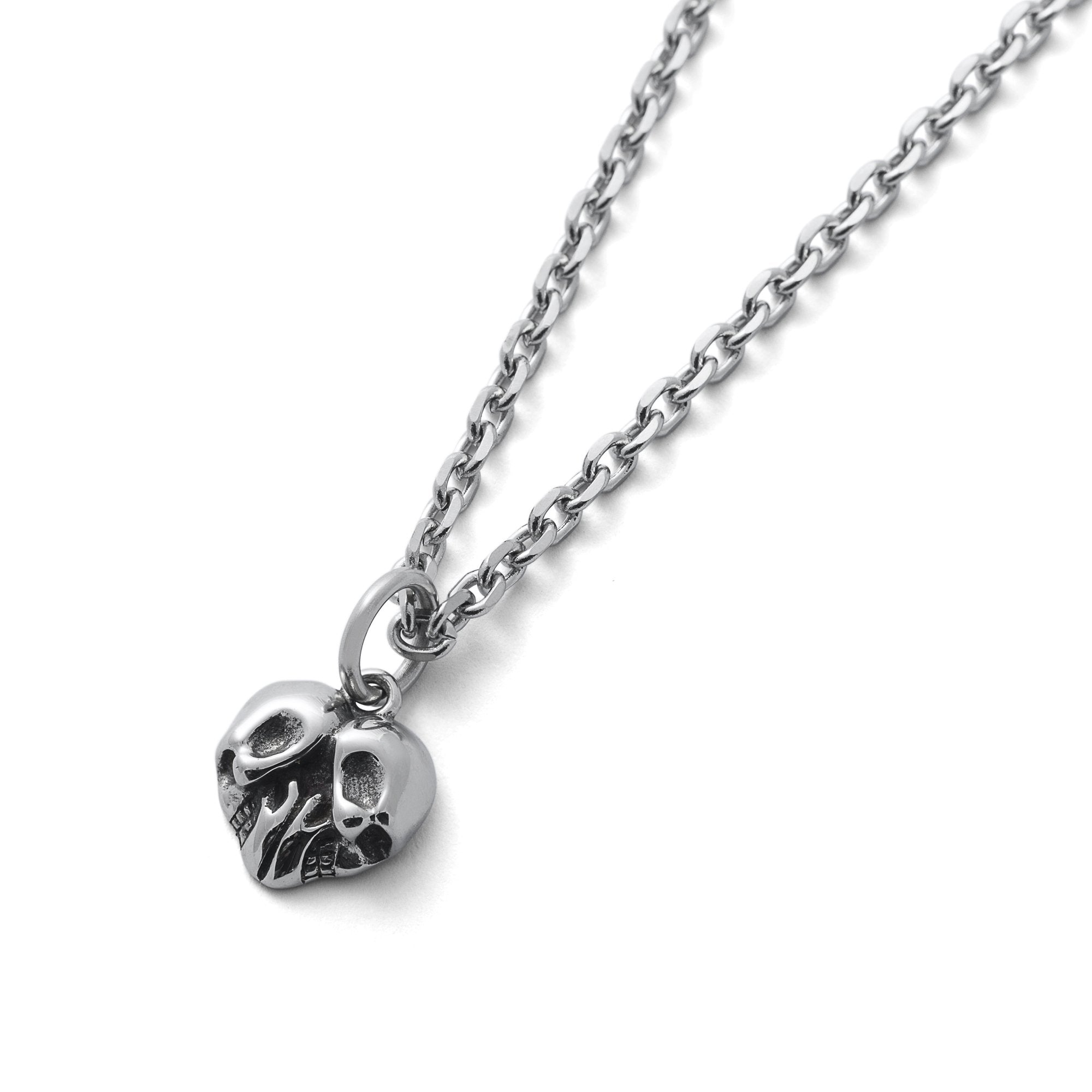 heart pendant shaped with 2 skulls by statement collective
