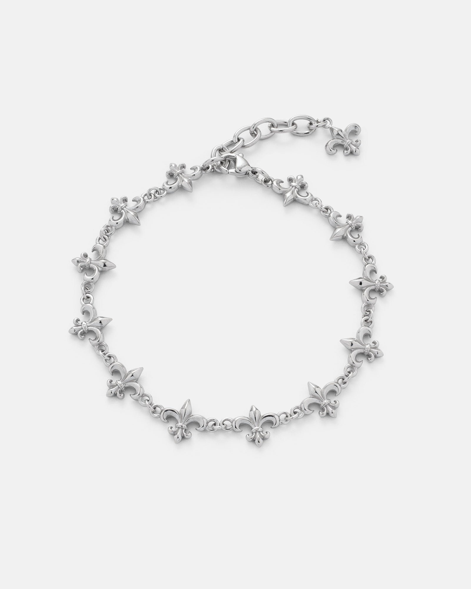 Statement Collective "Fleur De Lis" 10mm Bracelet showcased on a plain white background, featuring multiple small fleur-de-lis charms evenly spaced along the chain, finished with an adjustable clasp and extension chain.