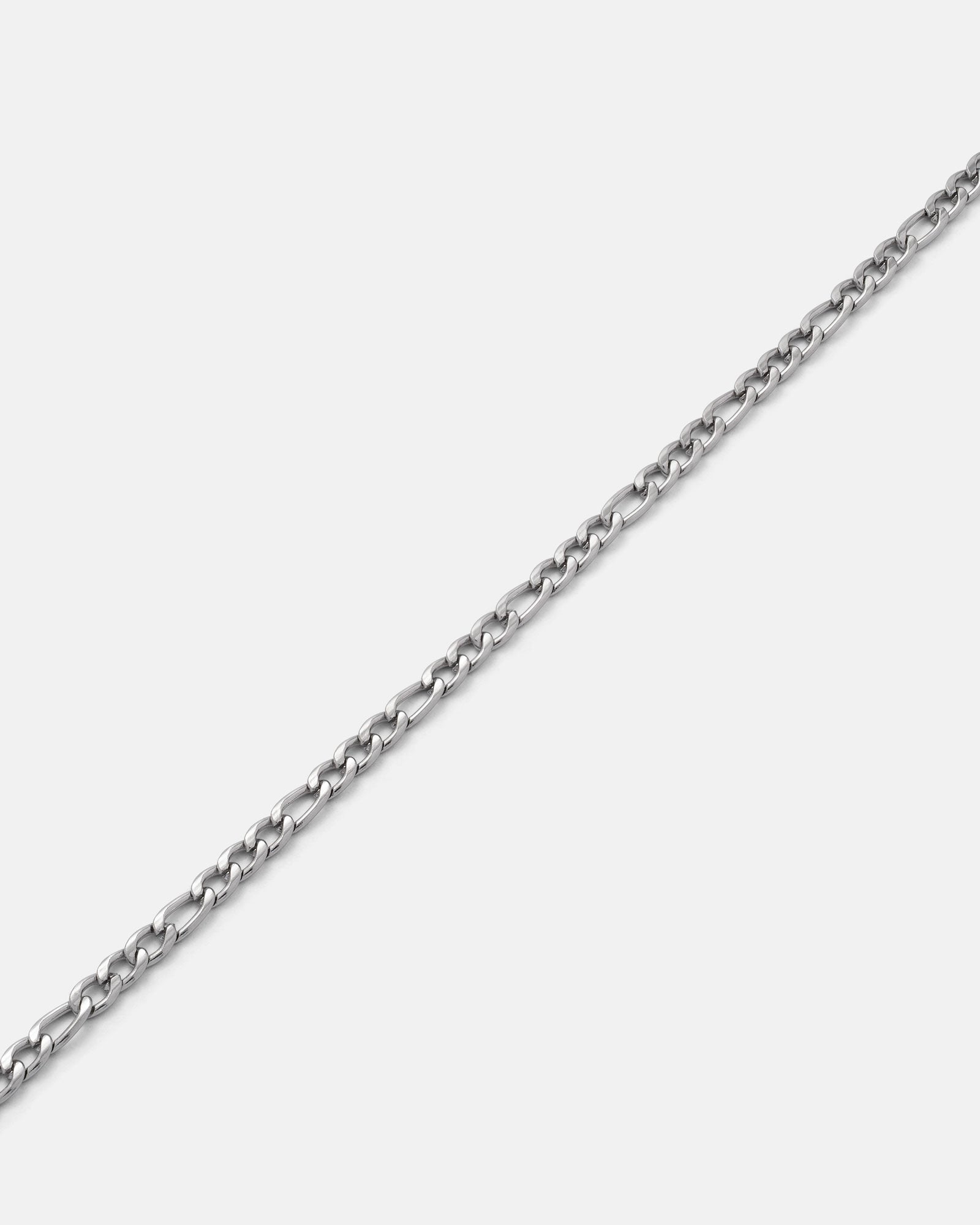 The 2.9mm Figaro Chain, featuring small, oval links and a non-tarnish finish, is displayed diagonally on a plain white background.