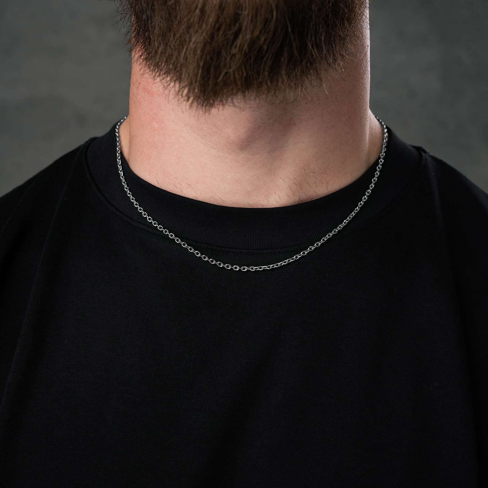 silver cable chain necklace on mens neck by statement