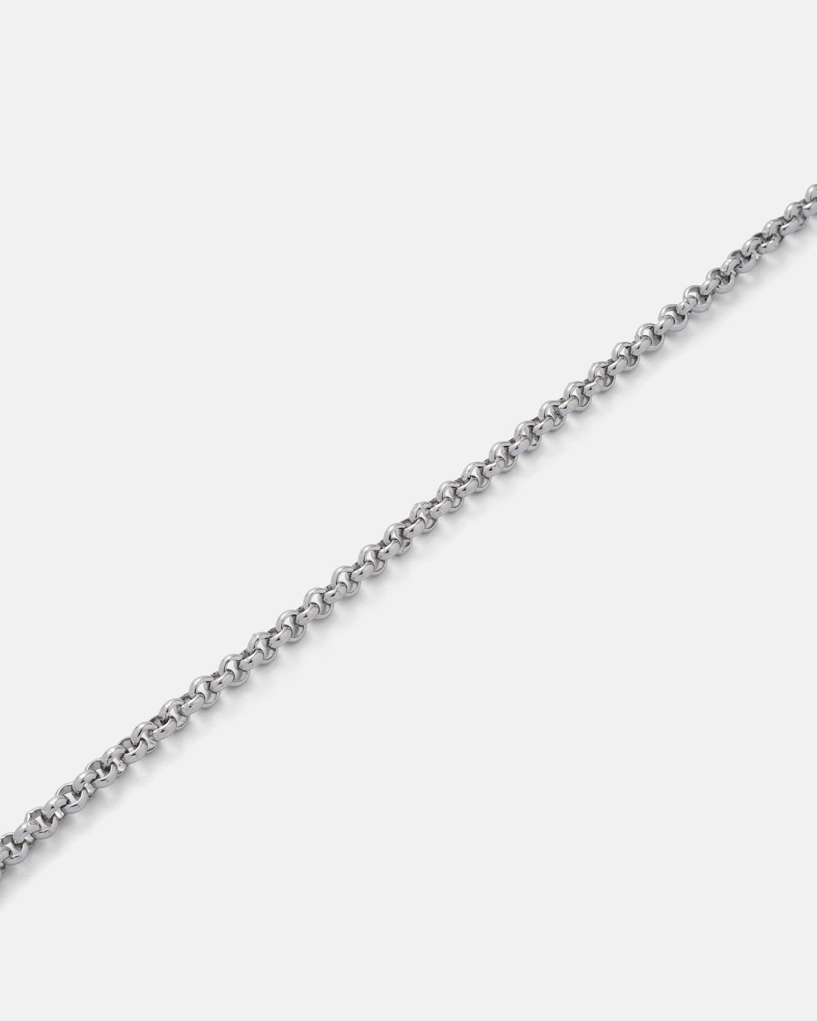 A close-up of the 4mm Rolo Chain, featuring small, round interconnected stainless steel links, shown diagonally on a plain light gray background.