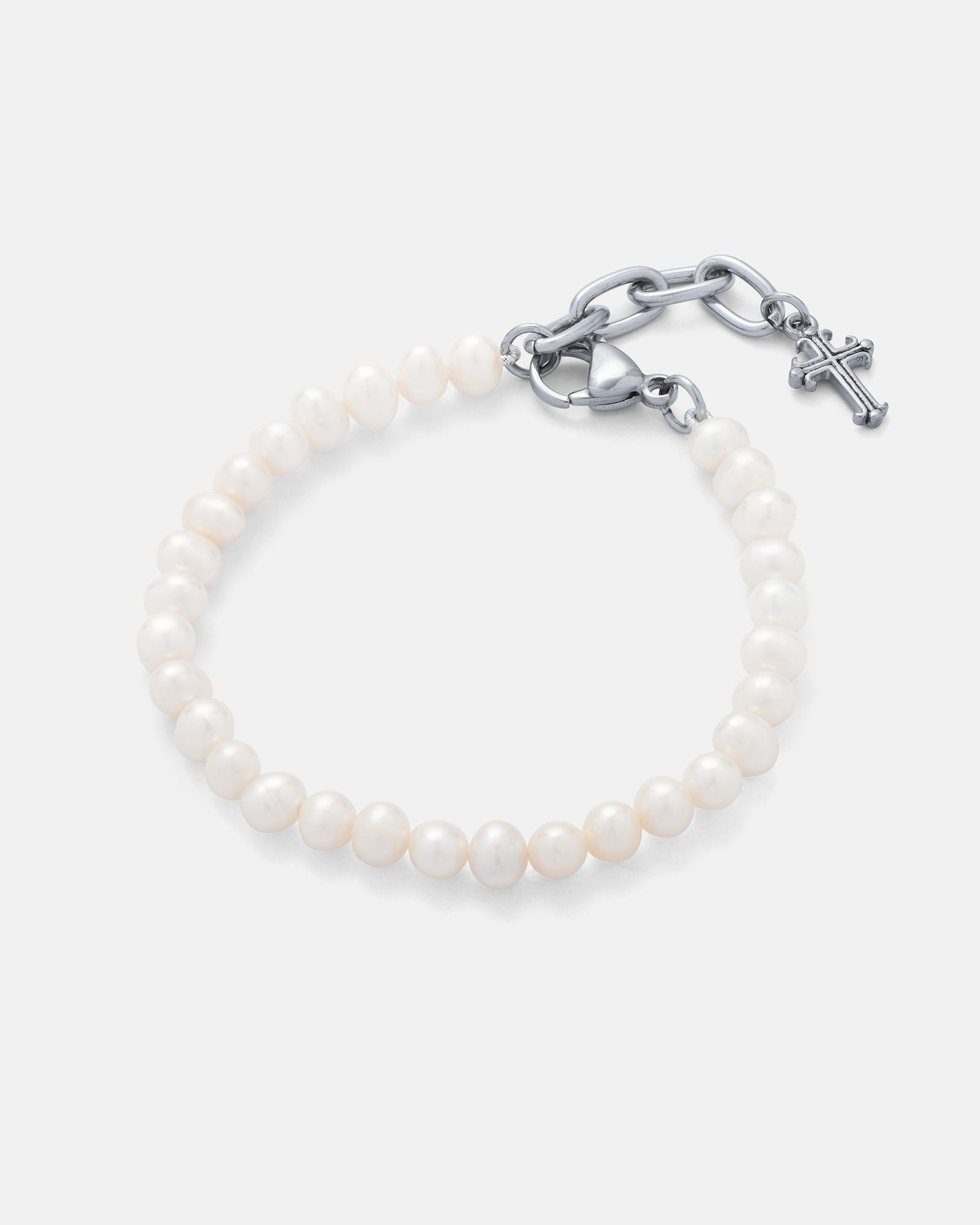 The 5mm Freshwater Pearl Bracelet features white pearls with a silver chain clasp, a small cross charm, and a stainless steel extender, shown against a plain grey background.