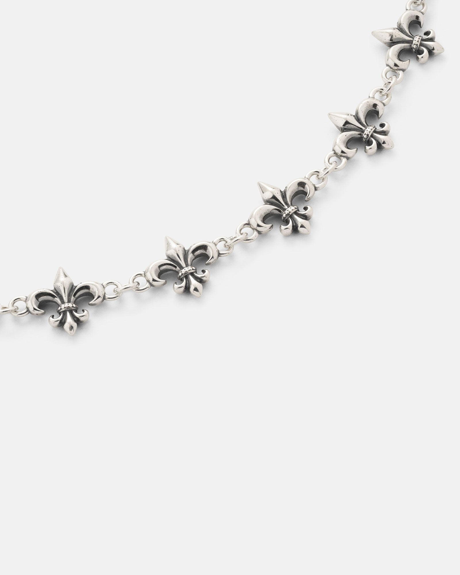 The Statement Collective 925 Sterling Silver "Fleur De Lis" 10mm Chain is showcased on a white background, featuring evenly spaced fleur-de-lis charms along its length.