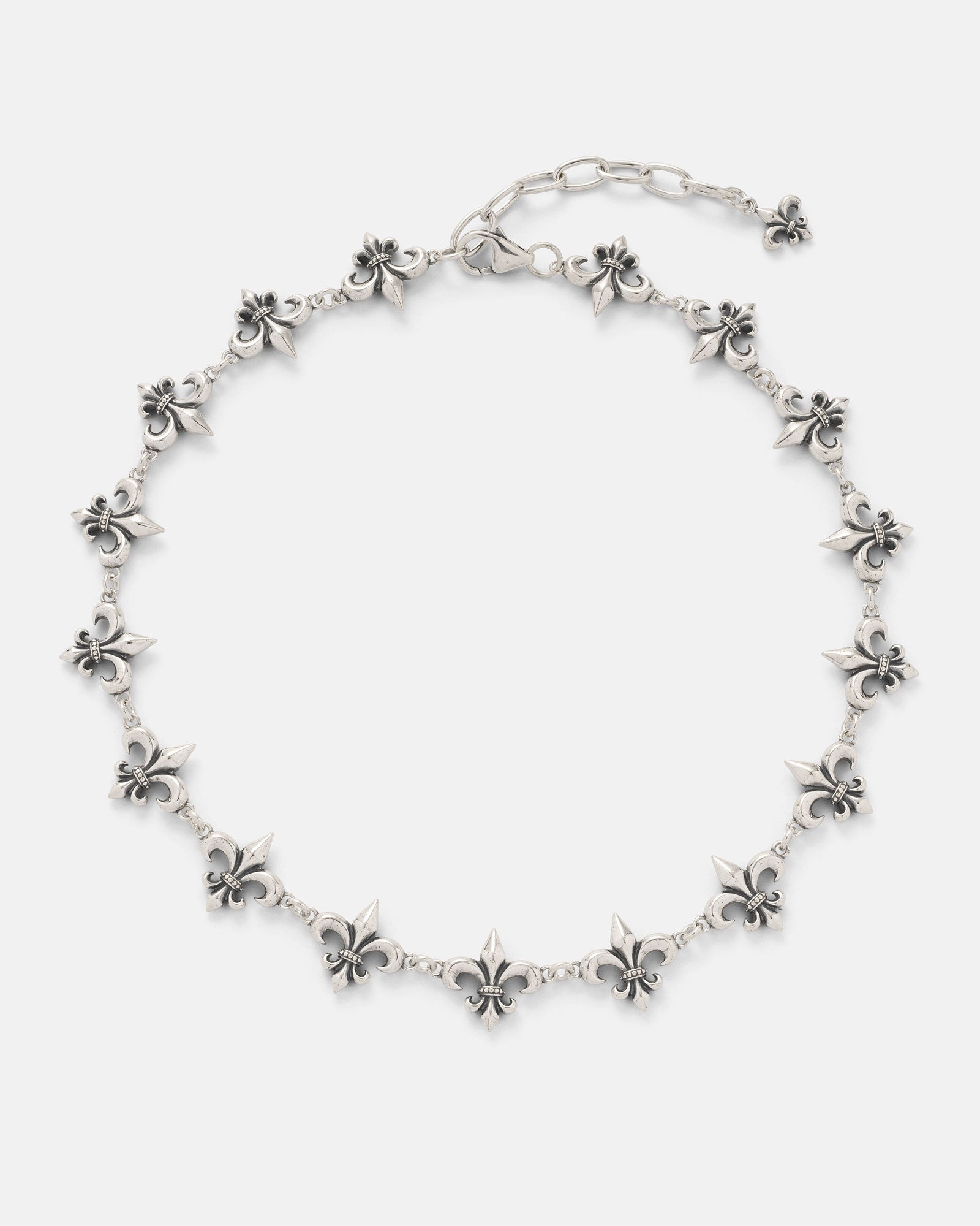 The Statement Collective 925 Sterling Silver "Fleur De Lis" 15mm Chain features evenly spaced fleur-de-lis charms linked together, an adjustable chain, and a small fleur-de-lis charm at the end.