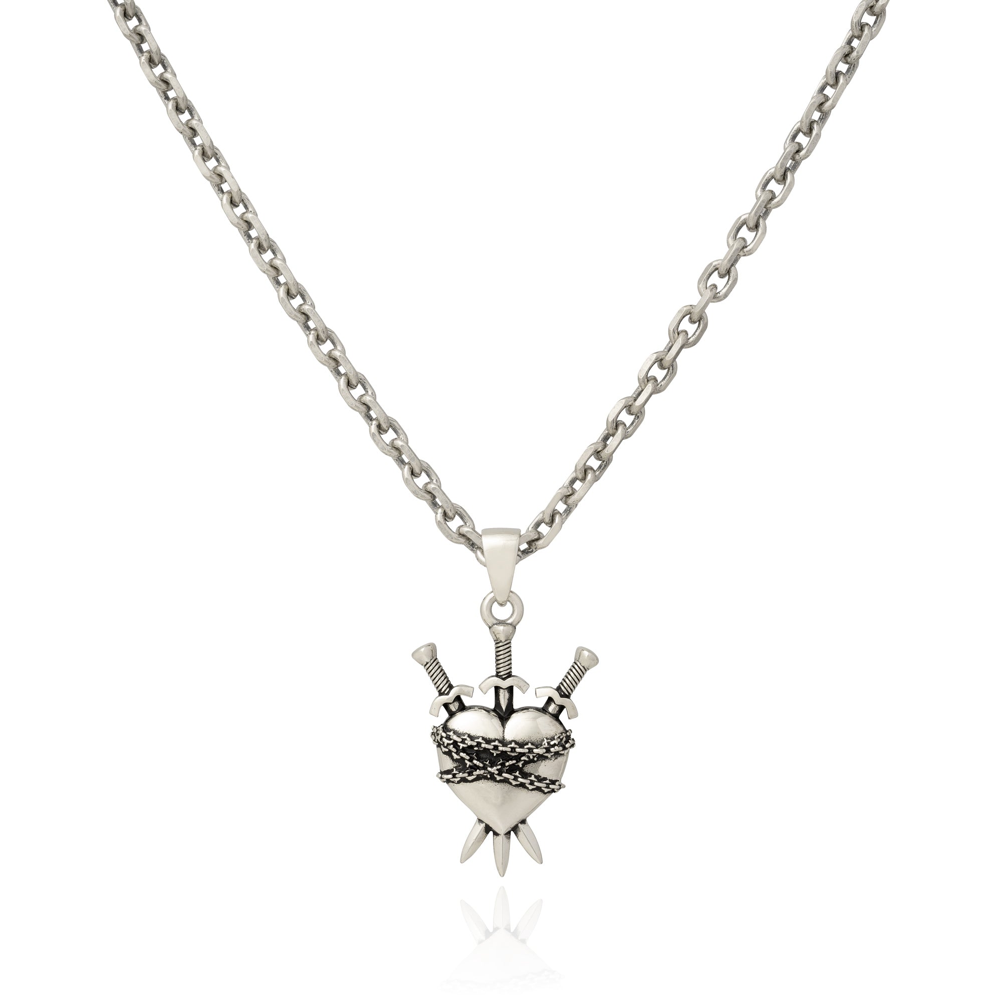Silver heart pendant with 3 swords going through it and wrapped in chain on white background 