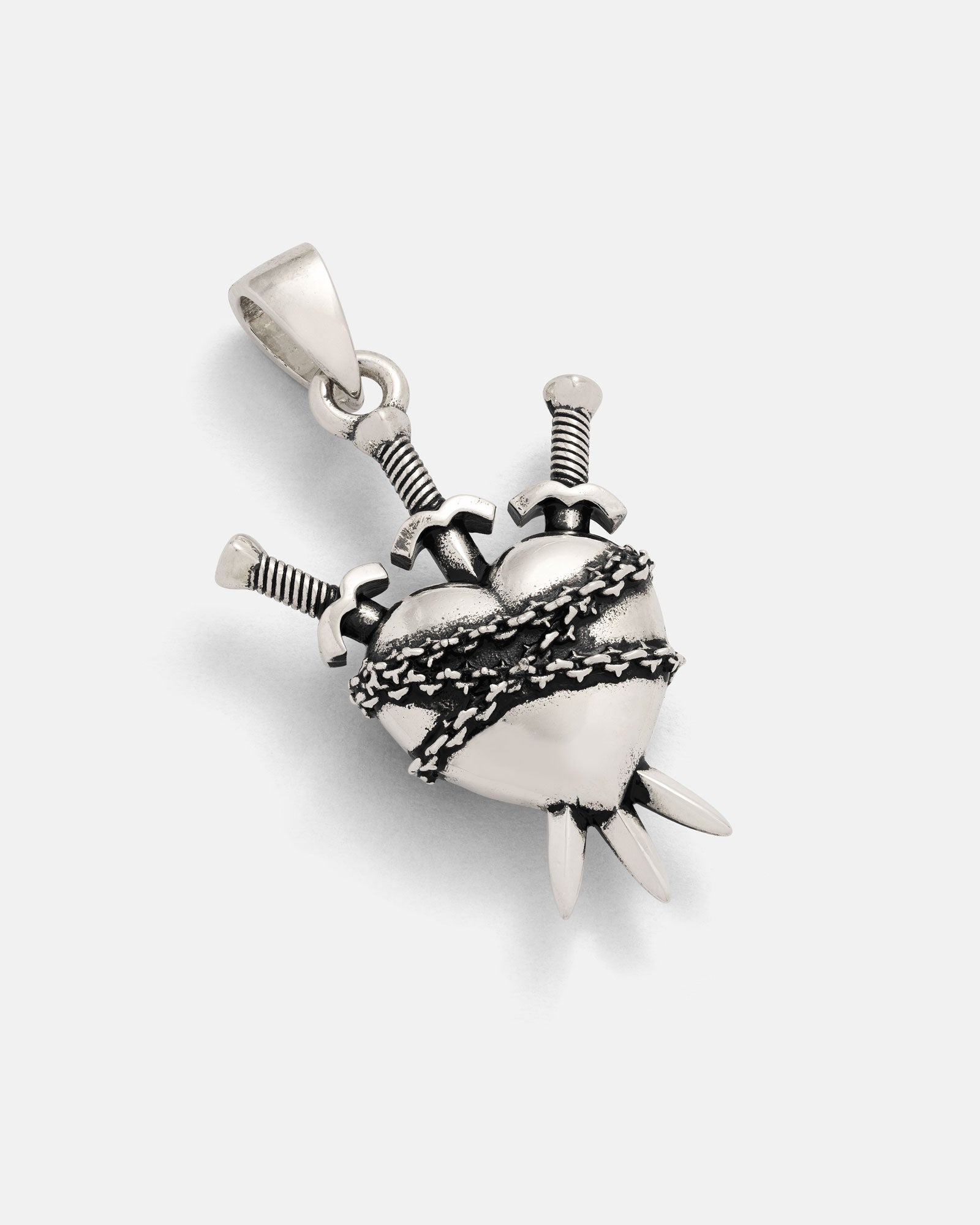 The 925 Sterling Silver "3 of Swords" Pendant features a heart wrapped in barbed wire and pierced by three swords, with pointed tips at the bottom and a bail for easy attachment to a necklace.