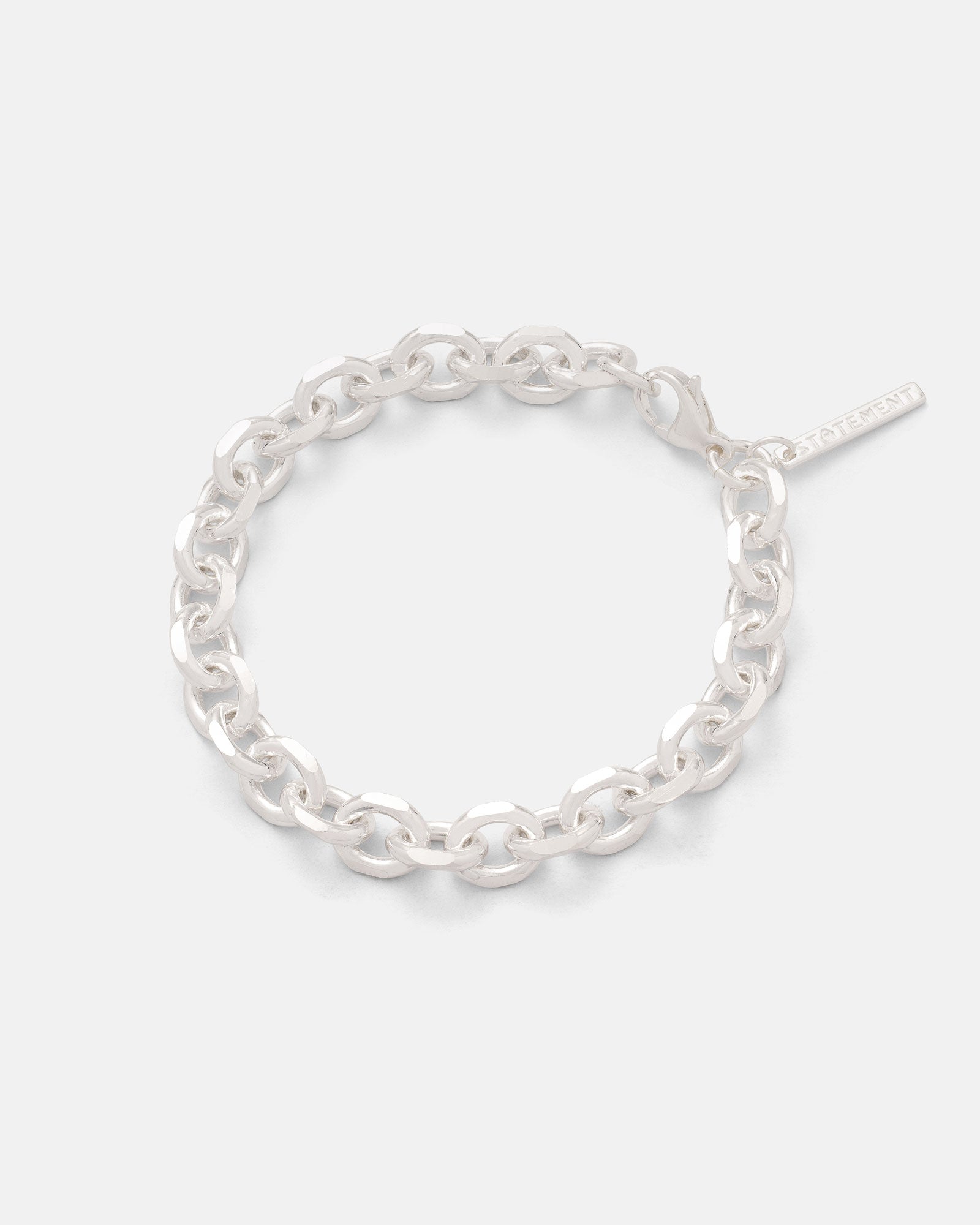 The Statement Collective 925 Sterling Silver 8mm Cable Bracelet features oval links and a small rectangular tag, shown on a plain light gray background.
