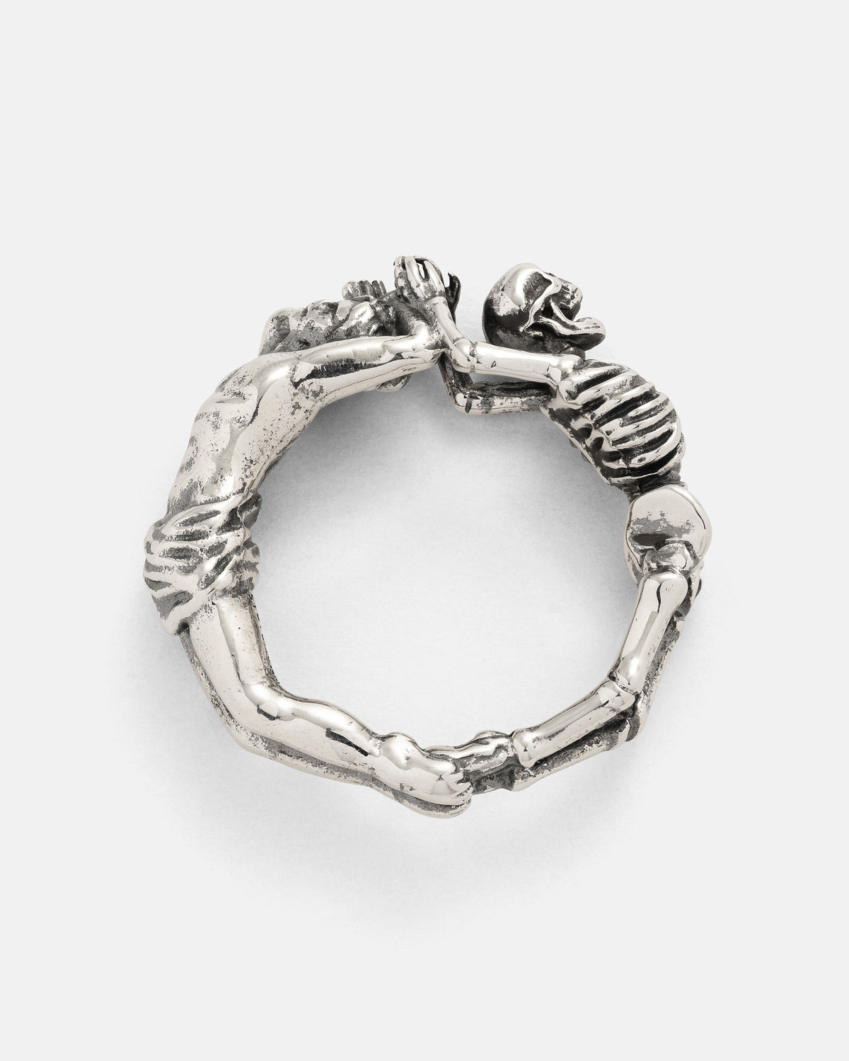 A 925 Sterling Silver Breaking Wheel Ring shaped like a skeleton curled into a circle, holding its own feet in a macabre Gothic design.