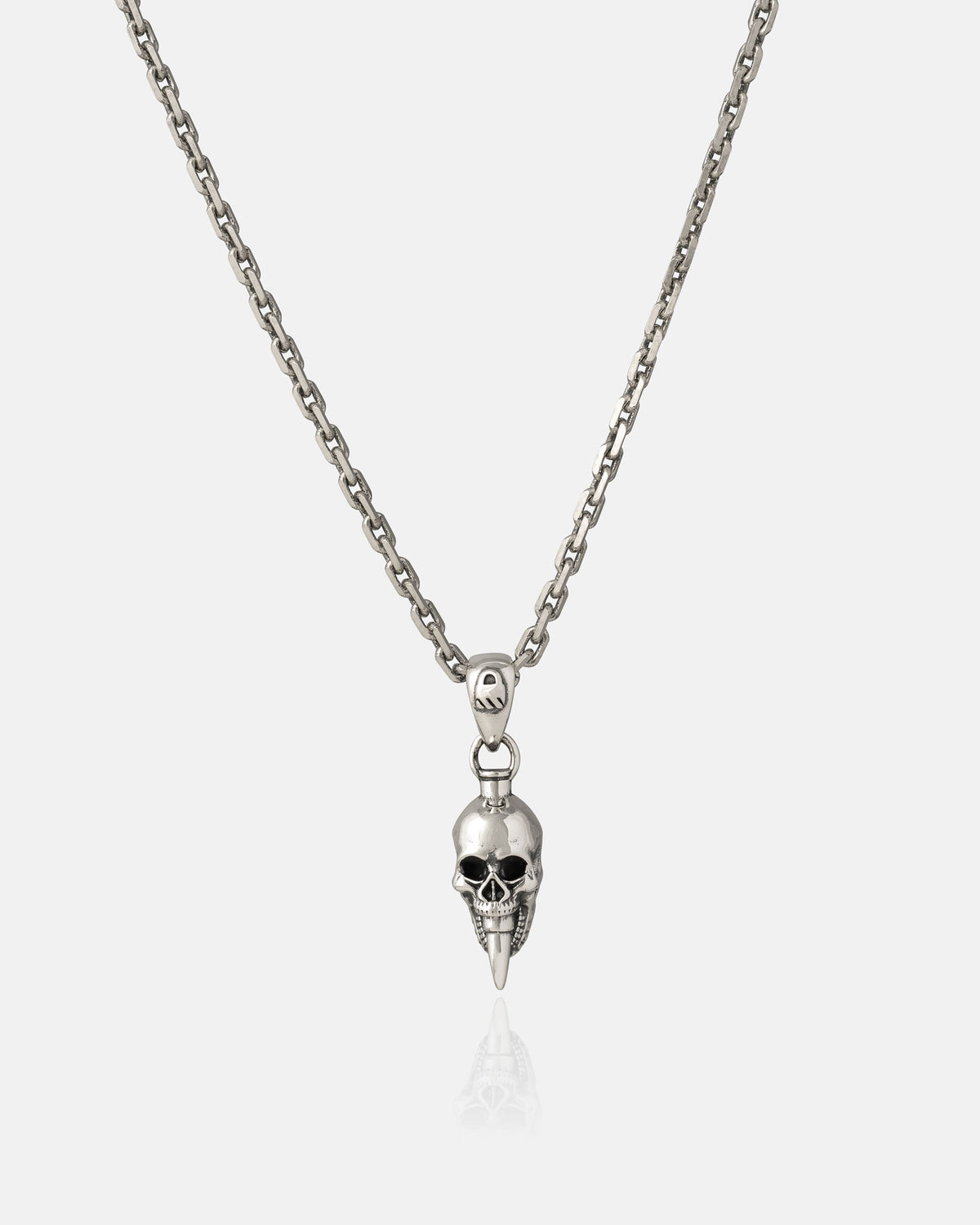 Showcase your edgy style with the Statement Collective 925 Sterling Silver Mini "Bite the Bullet" Pendant—a bold silver chain necklace featuring a detailed skull with a pointed chin, set against a plain white backdrop and perfect for making a rock-inspired statement.