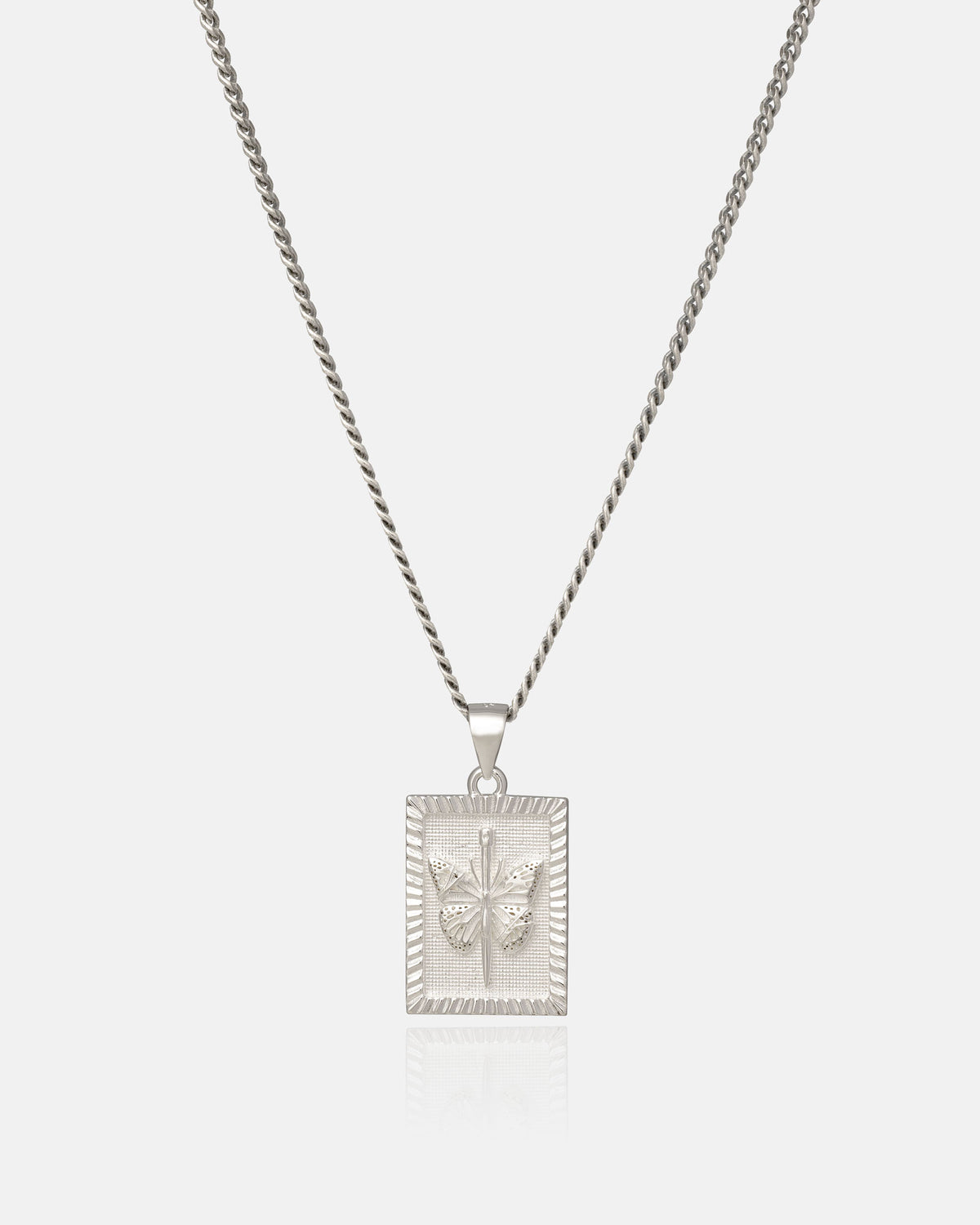 Experience sterling silver jewelry at its finest with the 925 Sterling Silver Mini Butterfly Tag Pendant by Statement Collective. This elegant necklace features a delicate chain and a rectangular pendant adorned with an embossed butterfly design at the center, beautifully displayed against a clean, white background.