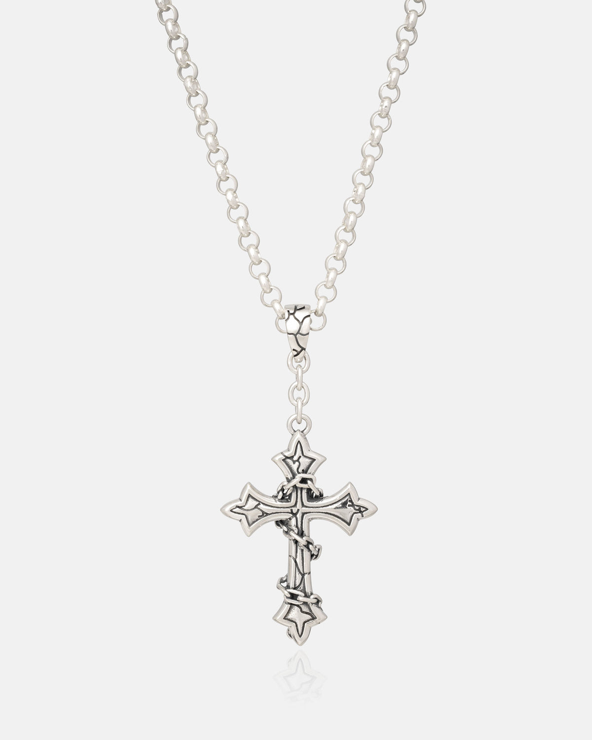 The Statement Collective 925 Sterling Silver Mini “The Ruins” Cross Pendant showcases a gothic-inspired jewelry design with pointed, star-like edges and a wrapped-chain detail, presented on a clean white background.