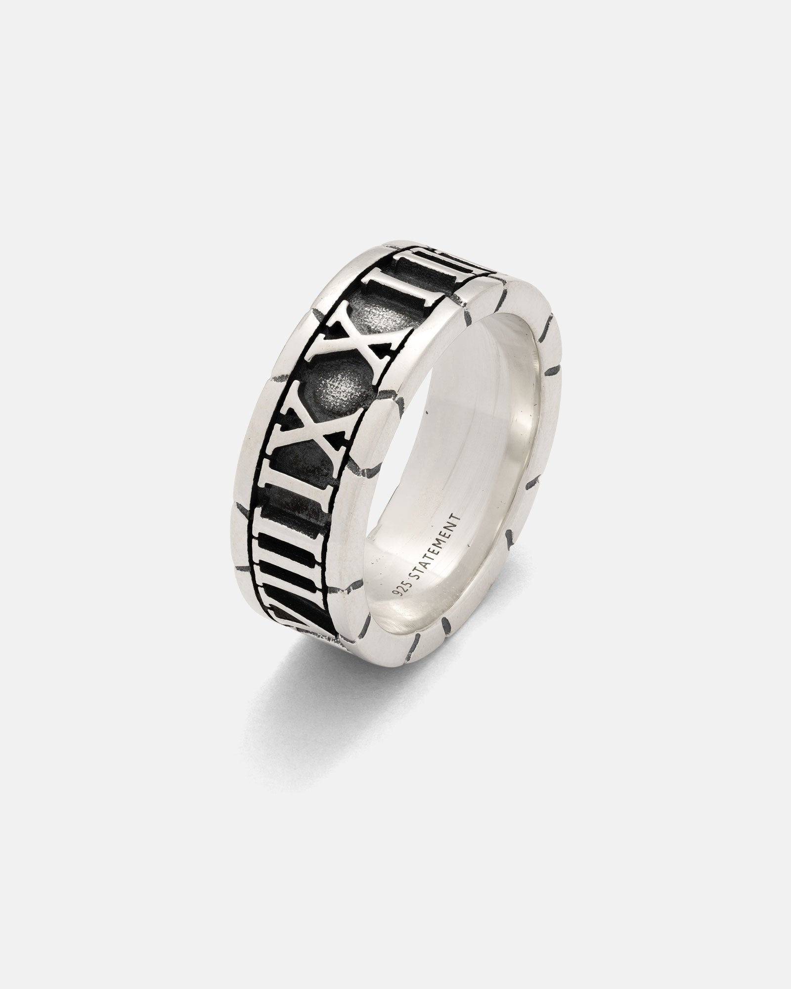 The 925 Sterling Silver Numerals Ring is a handmade silver band engraved with black Roman numerals and features a "925 STATEMENT" inscription inside, shown against a plain white background.