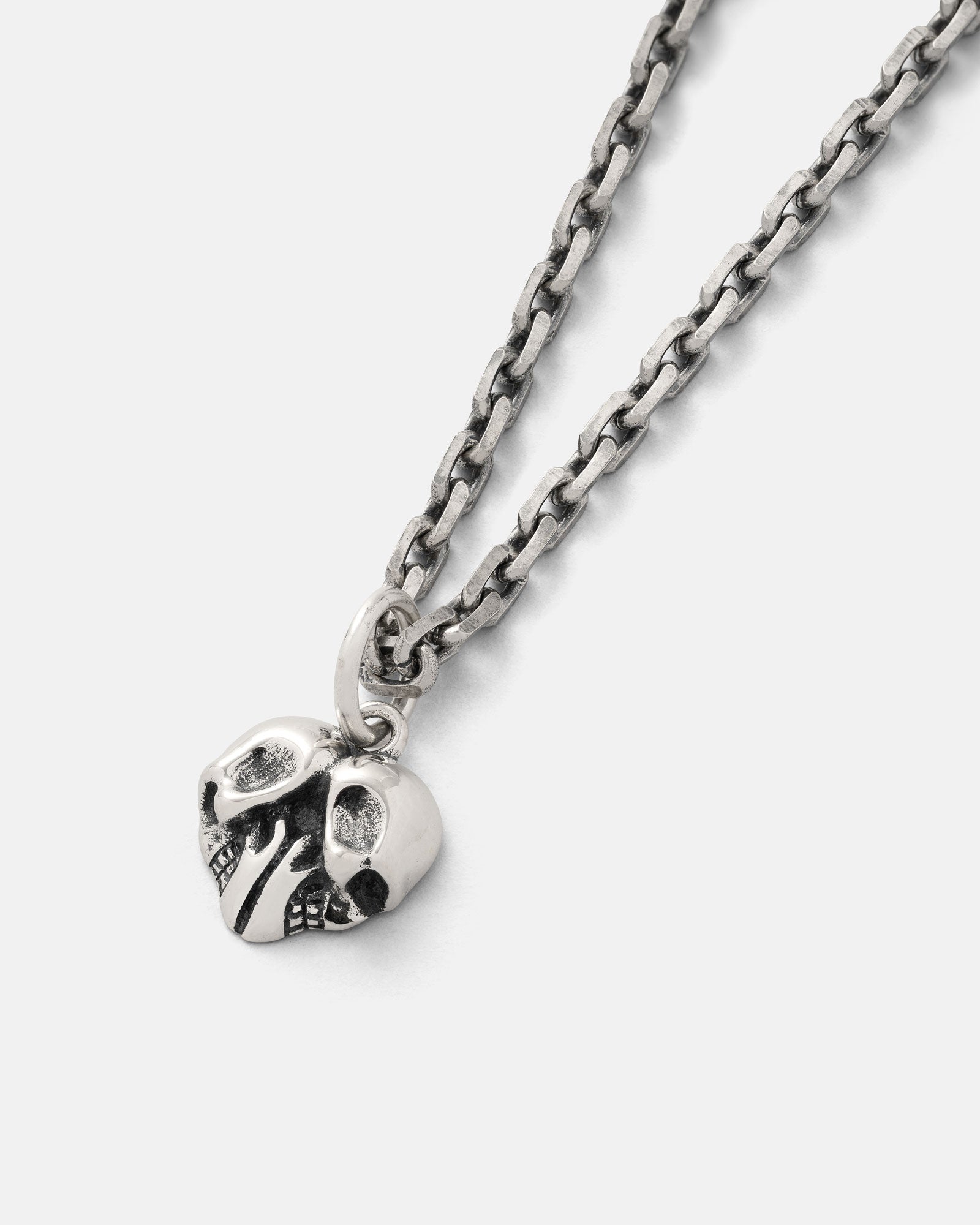 A close-up of the 925 Sterling Silver Skull Heart Pendant, featuring a detailed skull heart design and photographed on a plain white background—an edgy must-have for any rock jewelry collection.