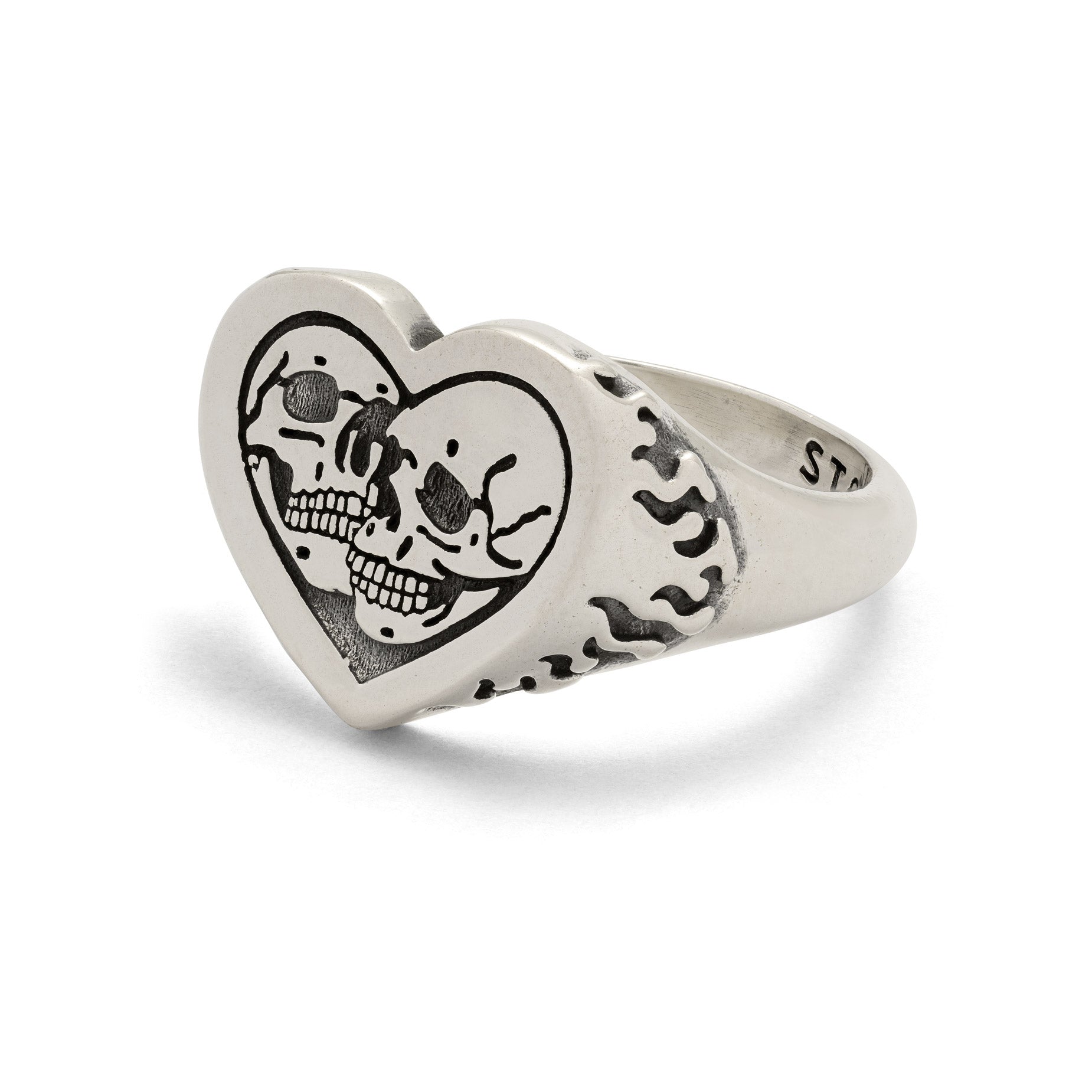 Sterling Silver heart shaped ring with skulls and flames on white background 