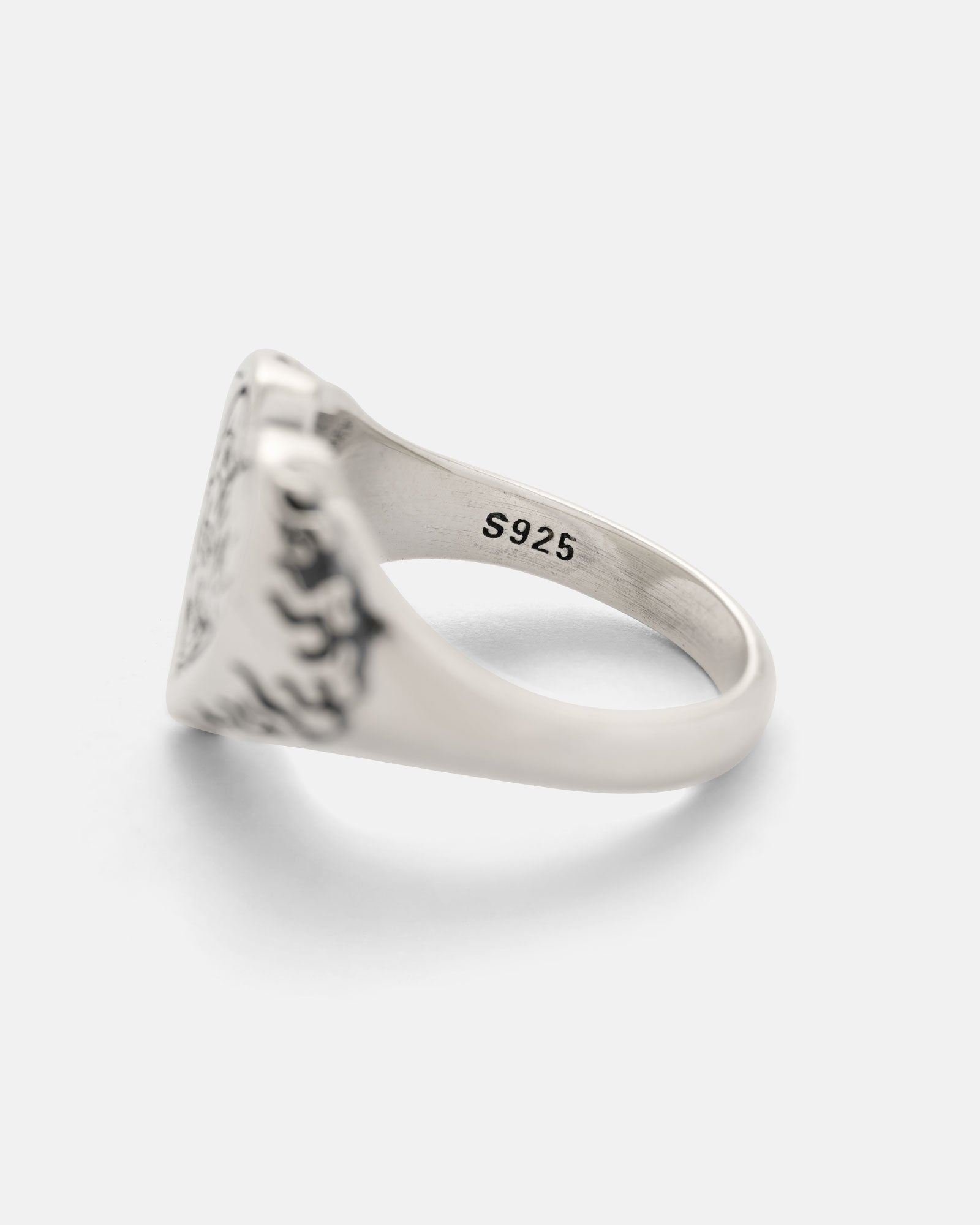 The 925 Sterling Silver Skull Heart Ring features an engraved skull heart design on its face and S925 stamped on the inner band, confirming its sterling silver quality. It is shown photographed against a plain white background.