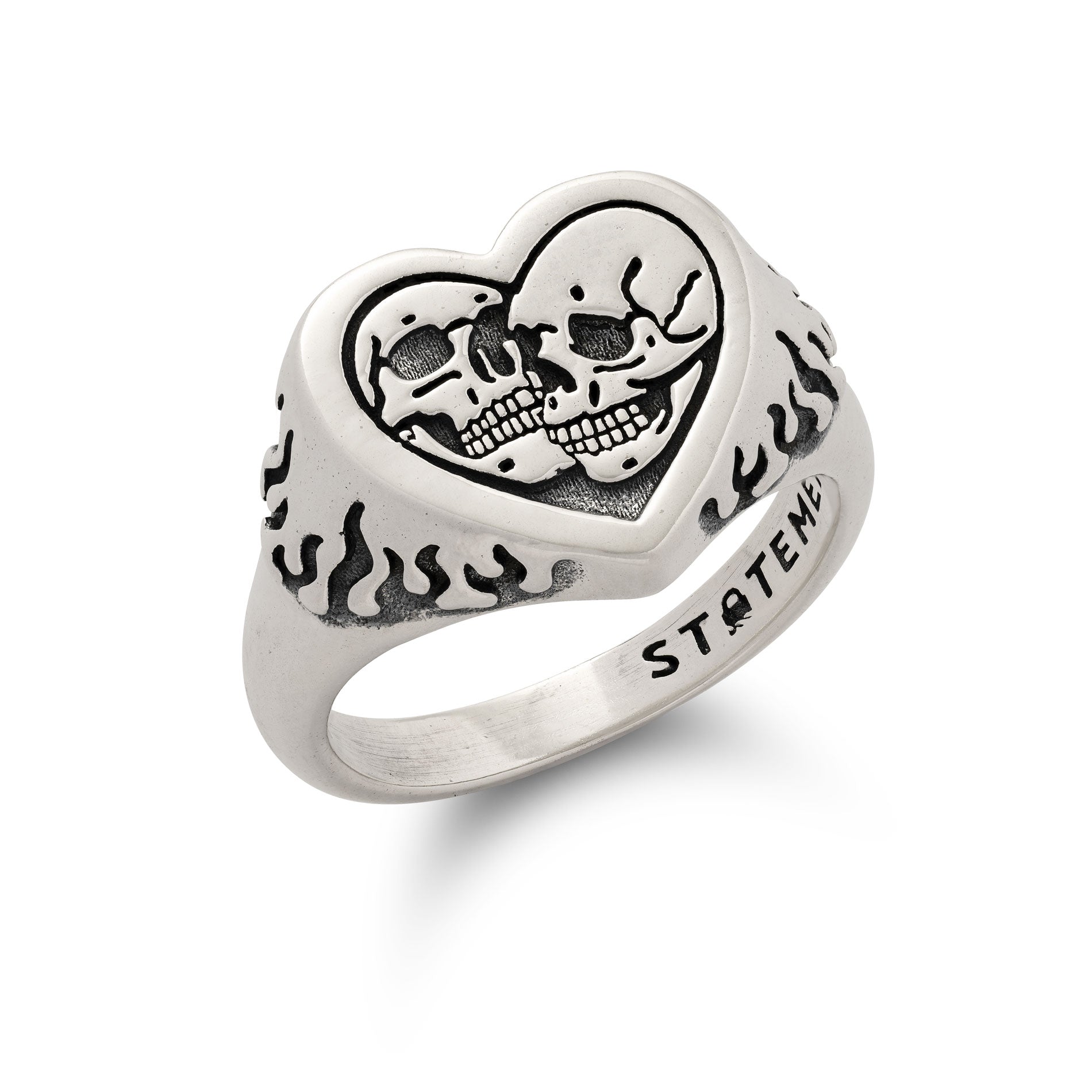 Silver heart-shaped ring with skull design and 'STATEMaENT' engraving on a white background
