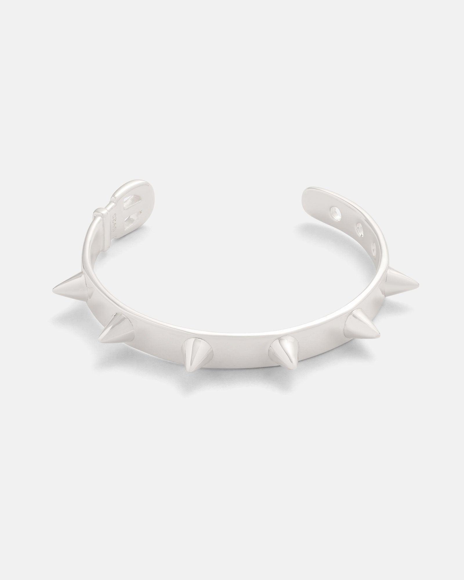 The Statement Collective 925 Sterling Silver Spiked Cuff Bracelet features evenly spaced, pointed spikes along its outer edge and is displayed against a plain white background.