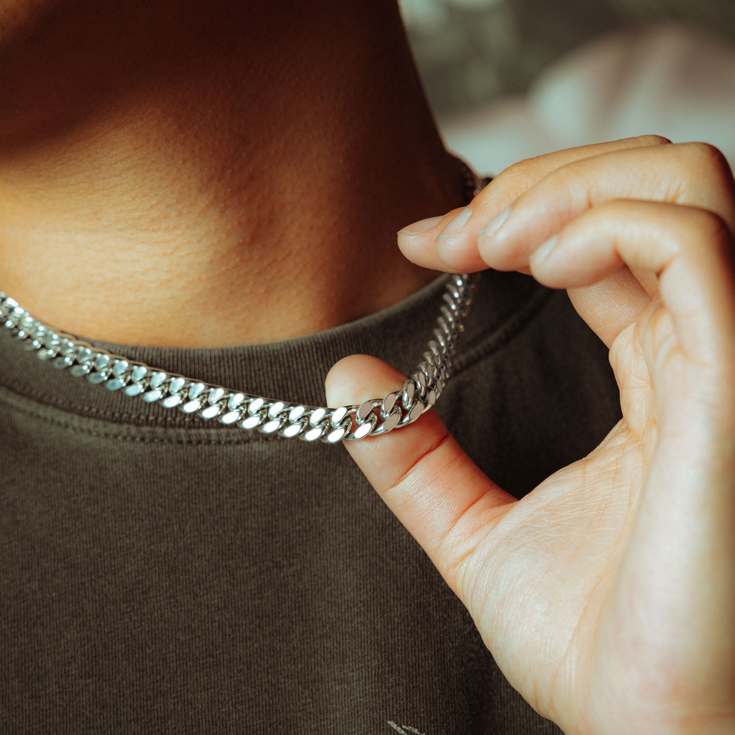 silver 9mm cuban chain on male model in sunglasses and grey shirt 