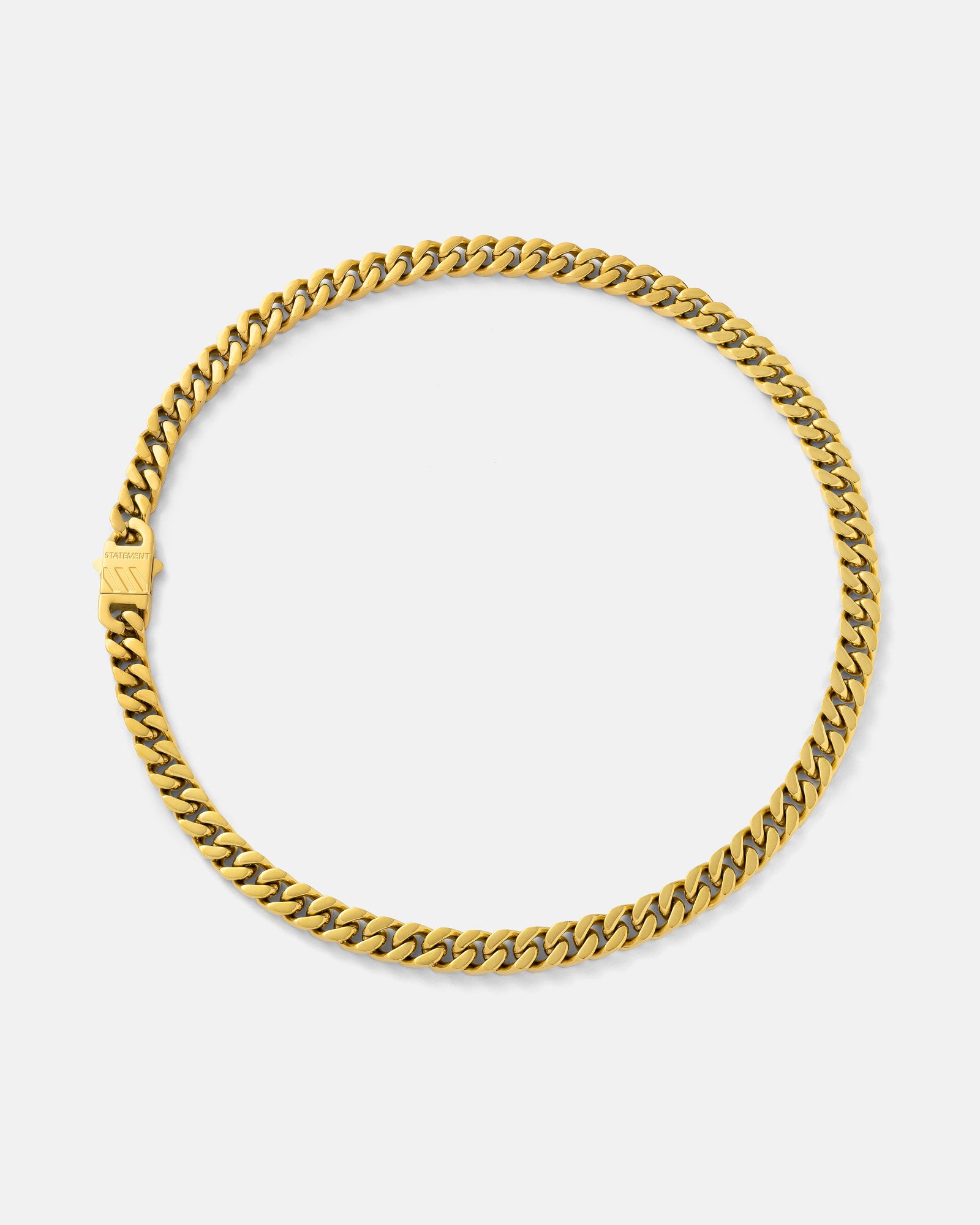 The 9mm Cuban Chain (Gold) showcases a flat curb link design with 18k gold plating and a rectangular clasp, arranged in a circular shape on a plain white background.