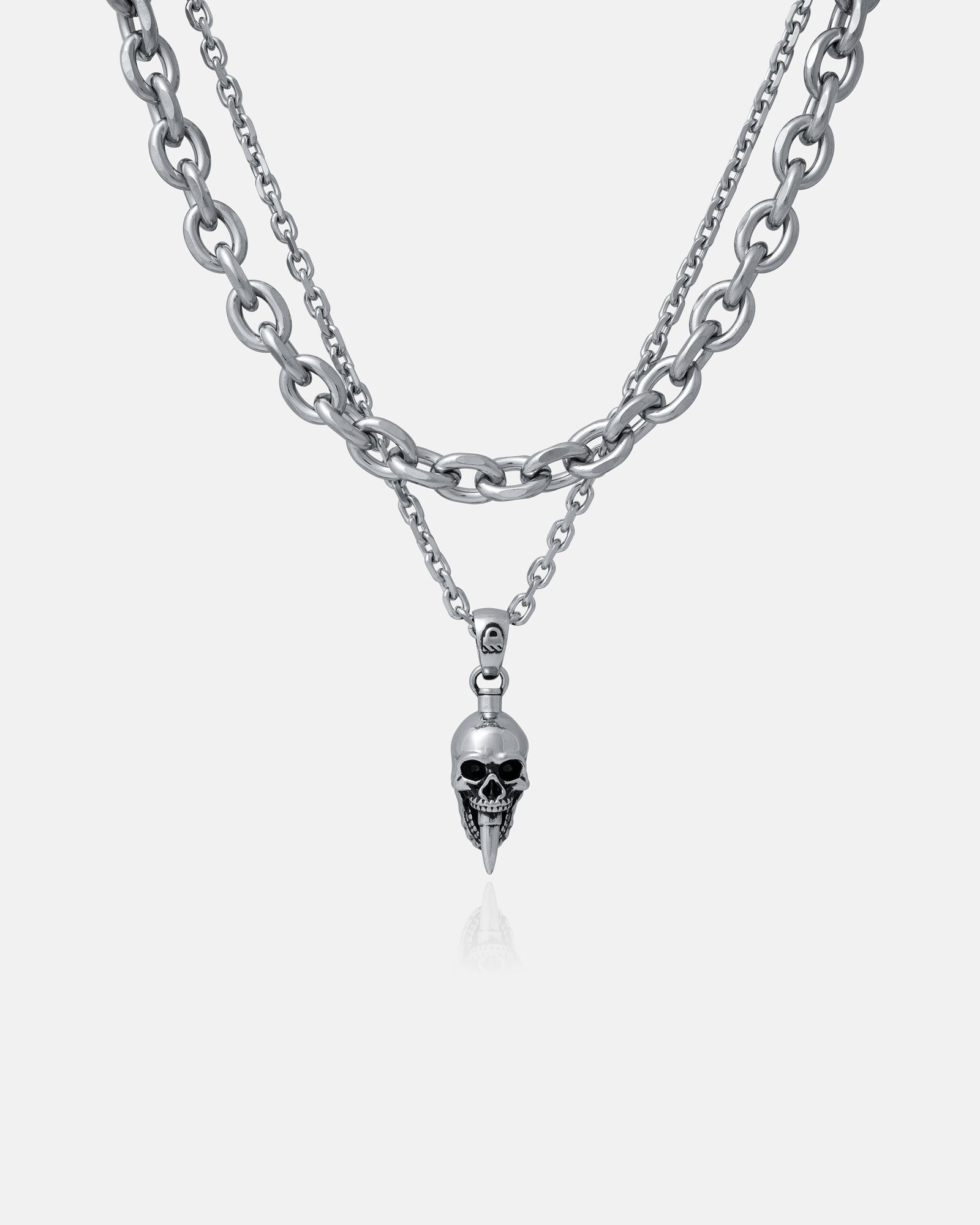 The Cable Set (Custom Pendant Choice) is a silver layered necklace with double cable chains and a skull-shaped pendant featuring pointed details, shown on a plain light gray background.