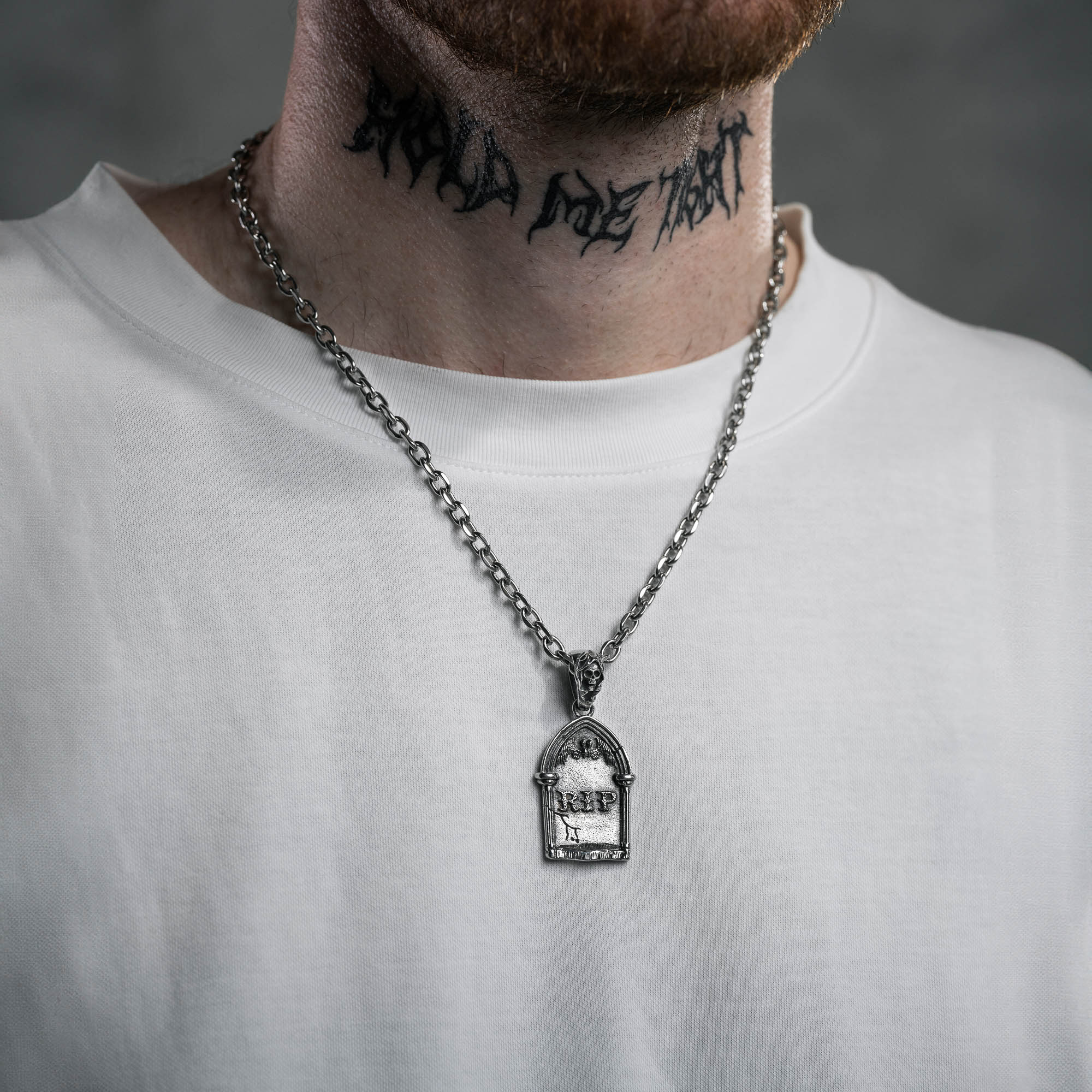 silver Gravestone pendant with Reaper Bale on a cable link chain, on male model with neck tattoo and white t shirt