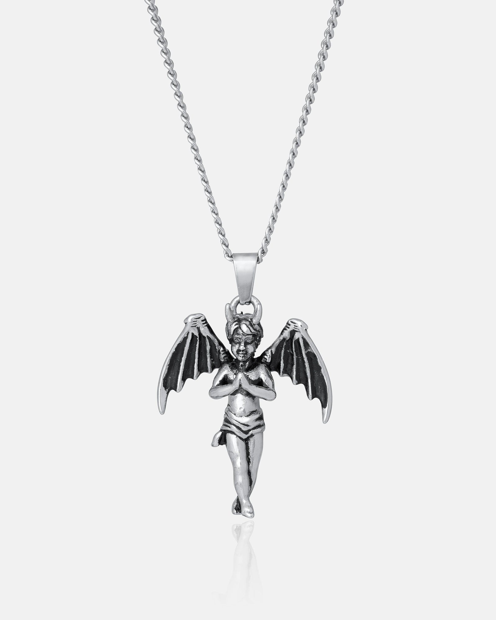 The Wicked One" Pendant is a silver gothic necklace with a detailed cherub pendant featuring bat-like wings, hanging from a fine chain against a plain white background.