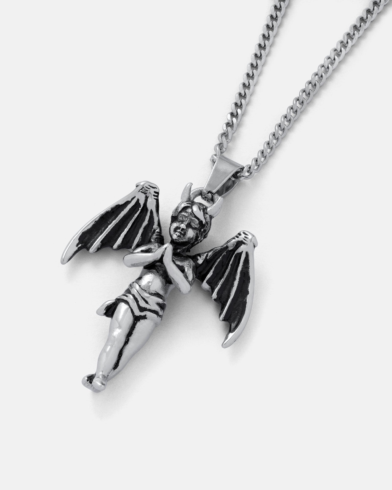 The Wicked One Pendant: a silver Gothic necklace showcasing a stainless steel angel with outstretched wings and clasped hands, displayed on a plain white background.