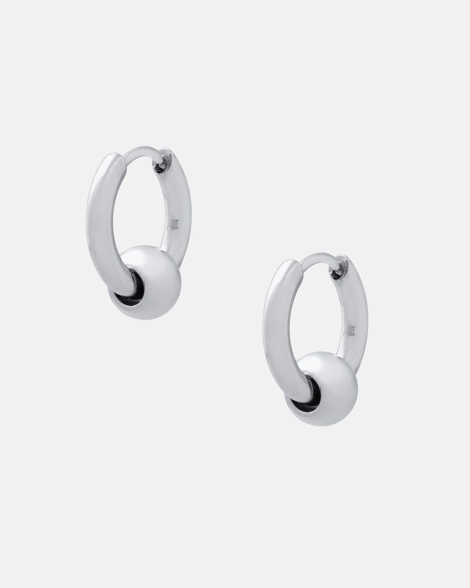 The Ball Hoop Earrings are small, hypoallergenic stainless steel hoops, each with a smooth silver bead at the center, shown on a plain white background.