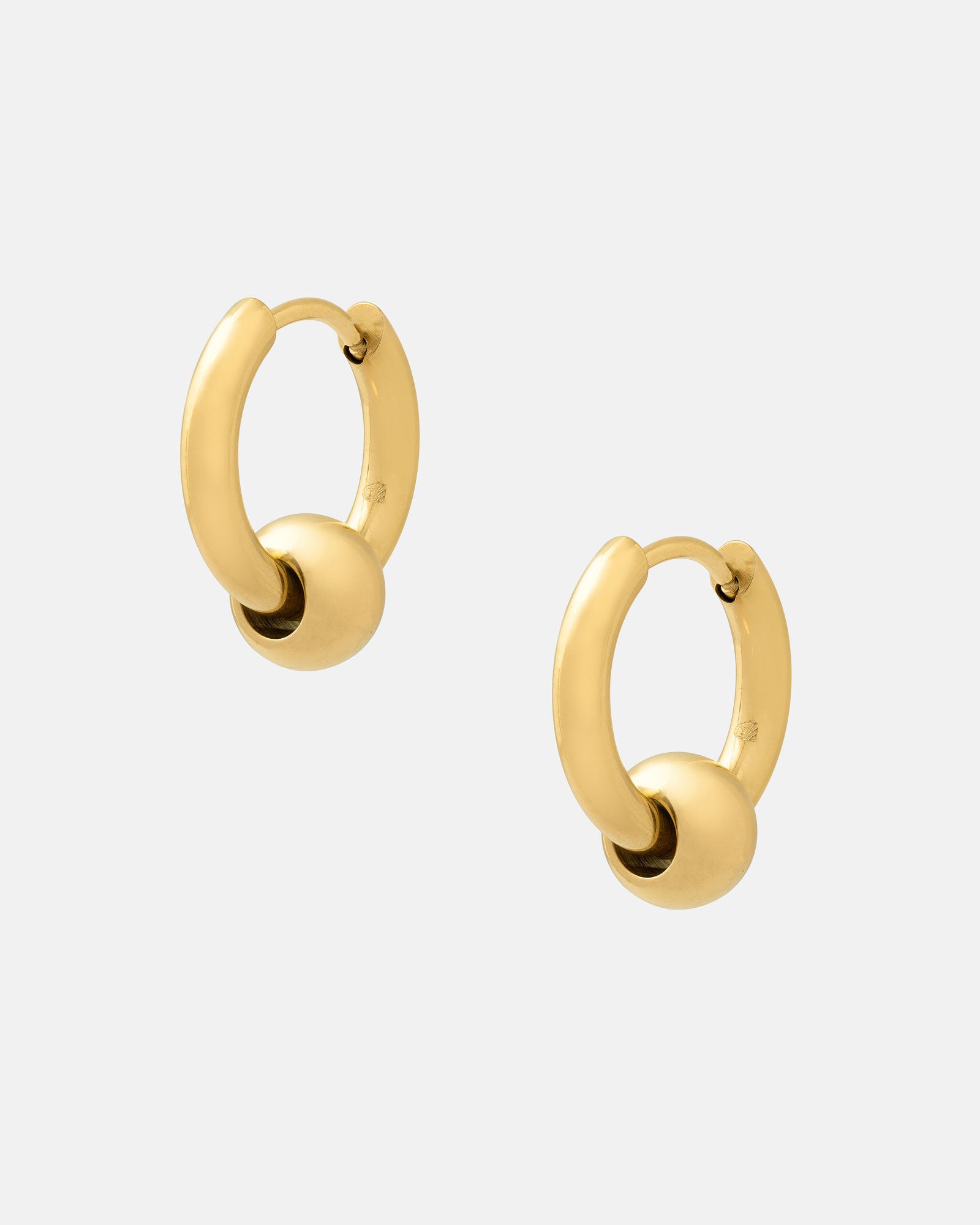 Ball Hoop Earrings (Gold), featuring 18k gold plating and a small gold sphere on each hoop, are hypoallergenic—ideal for sensitive ears. Shown against a plain white background.