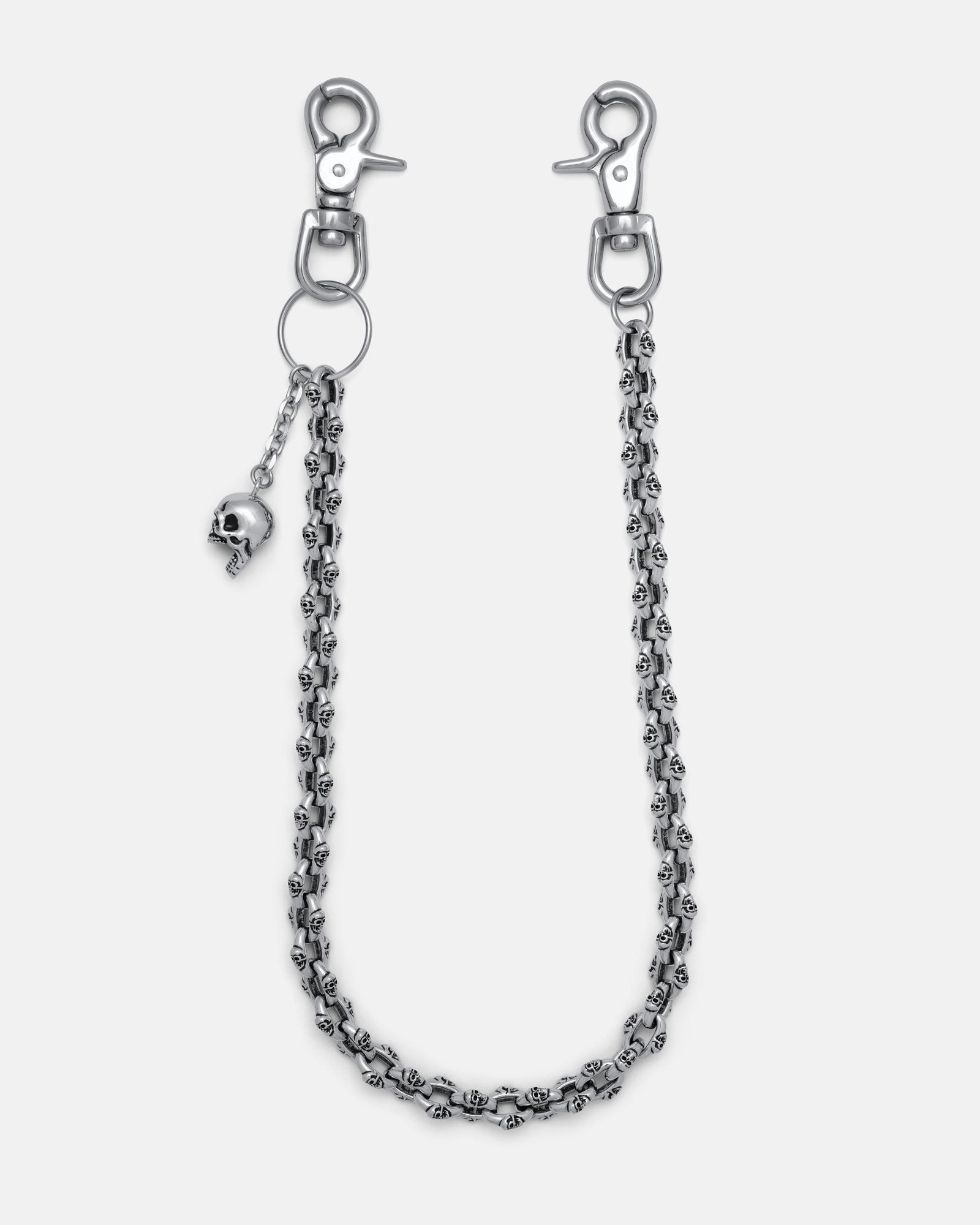 The "Boneyards" Skull Wallet Chain is a silver stainless steel accessory with two lobster clasps, small skull details along the chain, and a dangling skull charm near one clasp, shown on a plain light background.