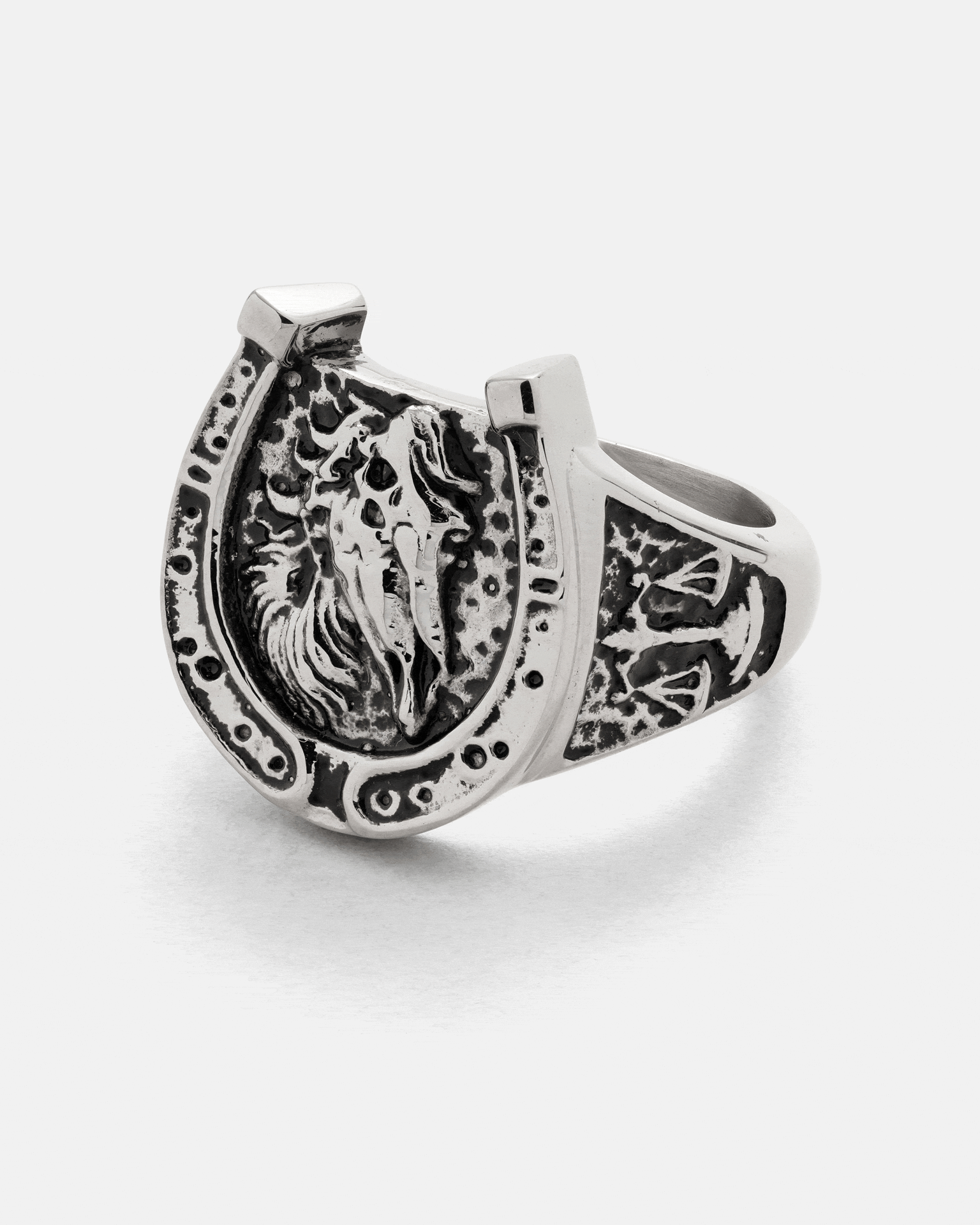 Bronco Ring by Statement Collective featuring a silver horseshoe-shaped band, an embossed horse head, and decorative rugged patterns.