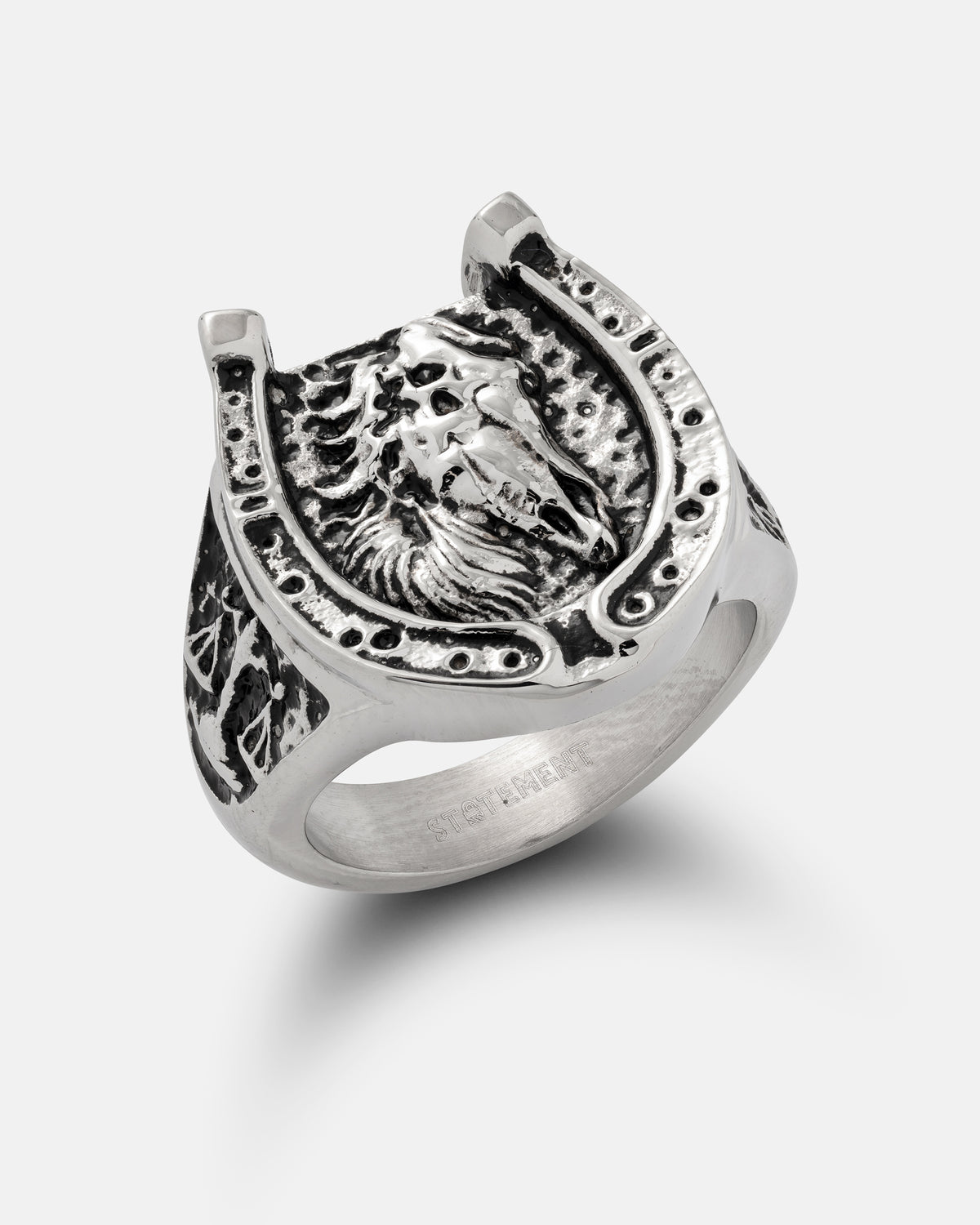 Statement Collective Bronco ring in stainless steel, featuring a horseshoe frame surrounding a horse head motif.