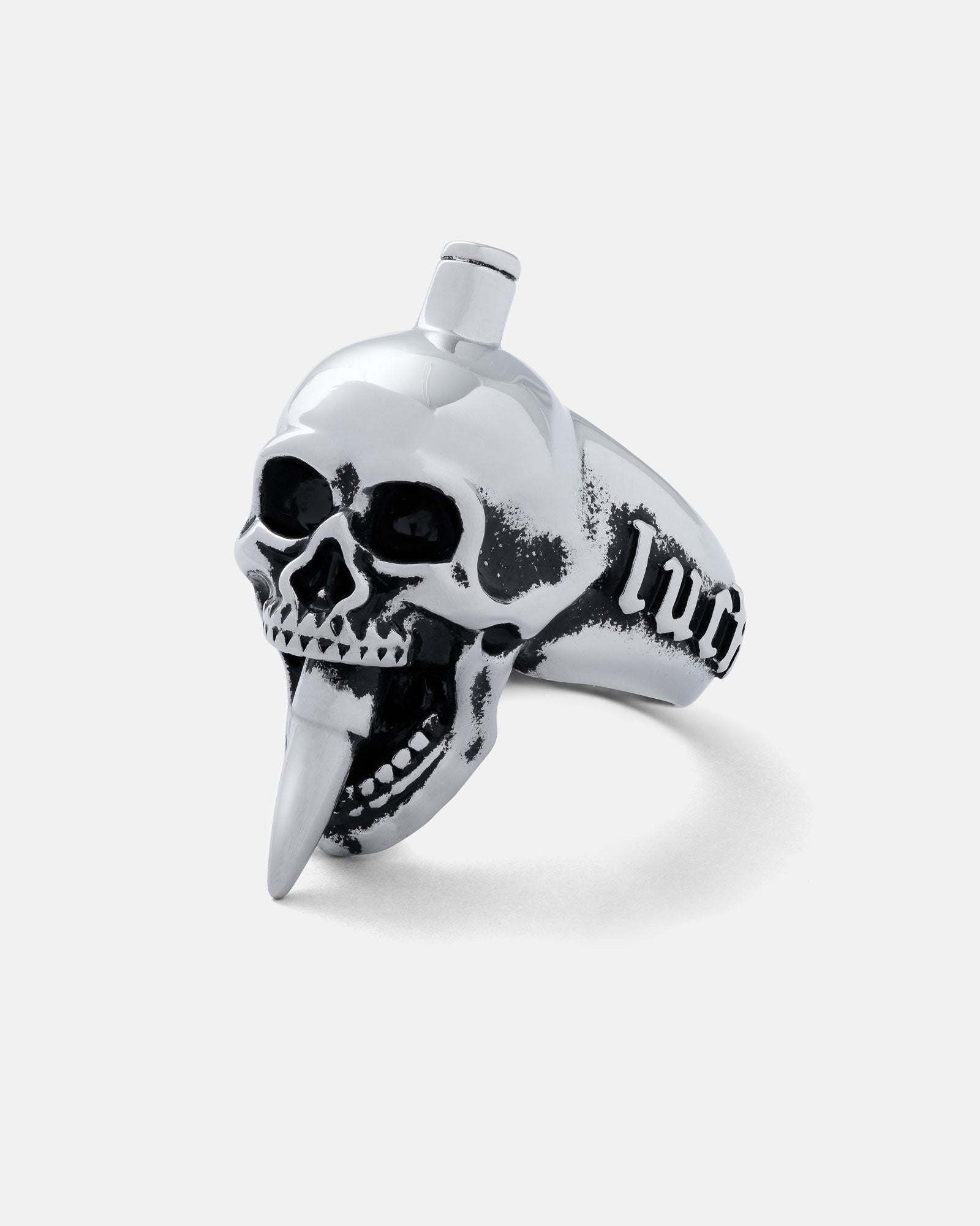 The "Bite The Bullet" Ring is a bold stainless steel skull ring featuring black eye sockets, an open mouth with a pointed tongue, and engraved "lvc" on the side—a standout piece of rock jewellery.
