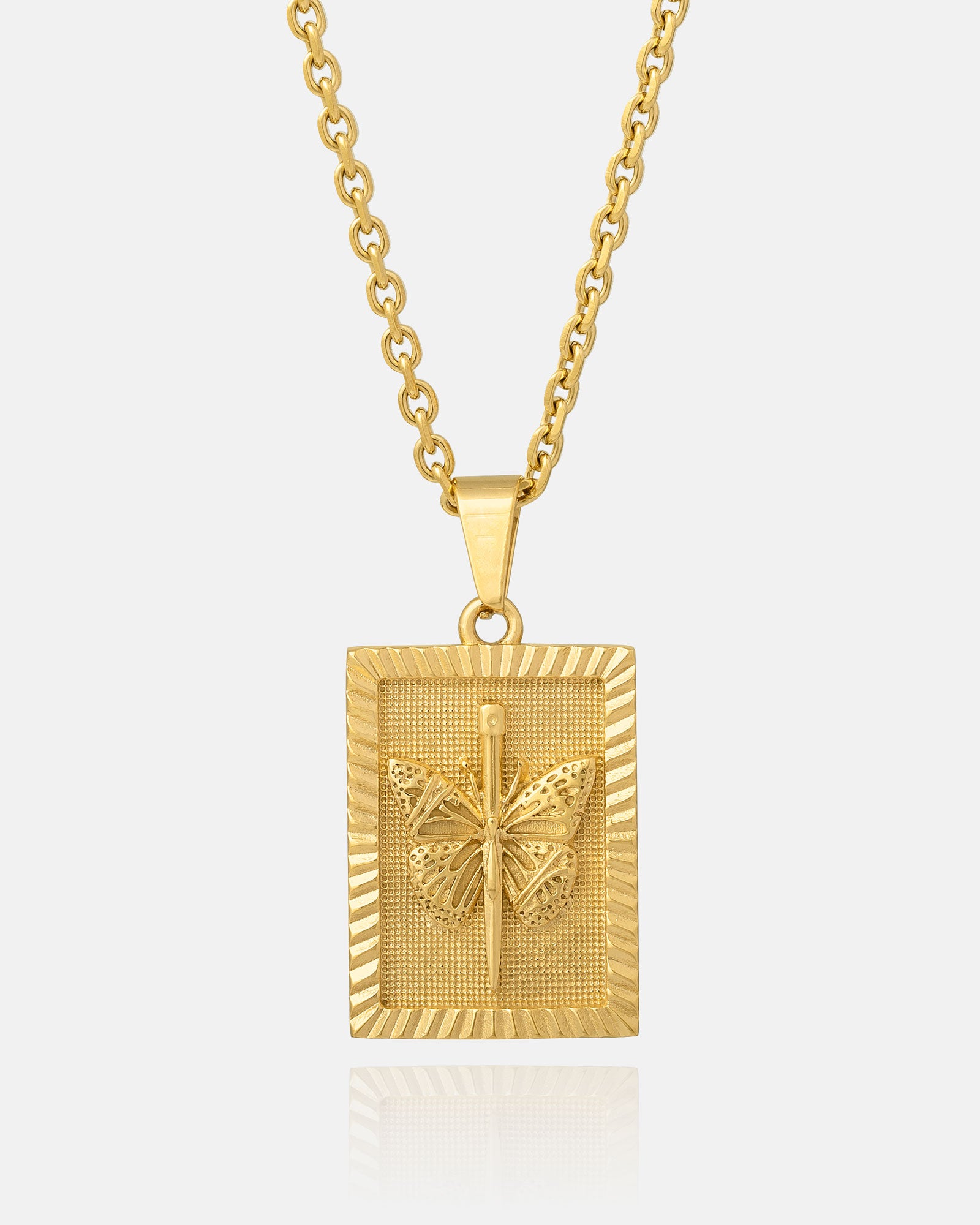 The Butterfly Tag Pendant (Gold) is an 18K gold plated necklace with a rectangular, textured pendant featuring a raised butterfly design, shining beautifully against a white background.