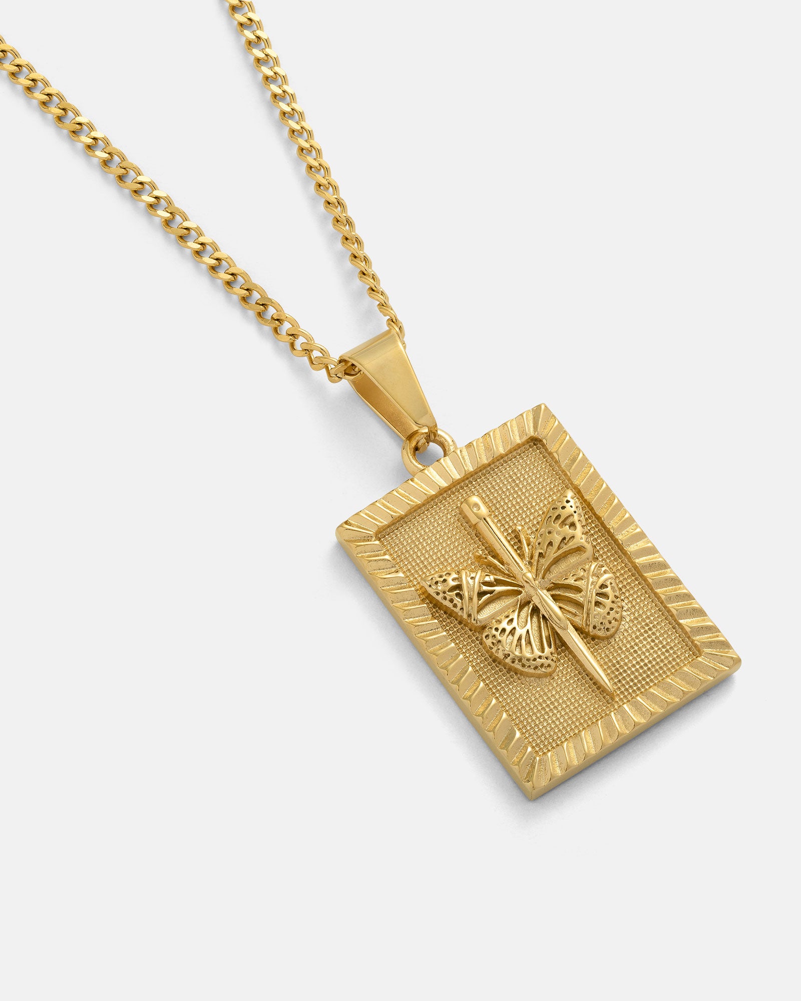 The Butterfly Tag Pendant (Gold) is an elegant 18K gold plated necklace featuring a raised butterfly design at its center, displayed on a matching chain against a white background.
