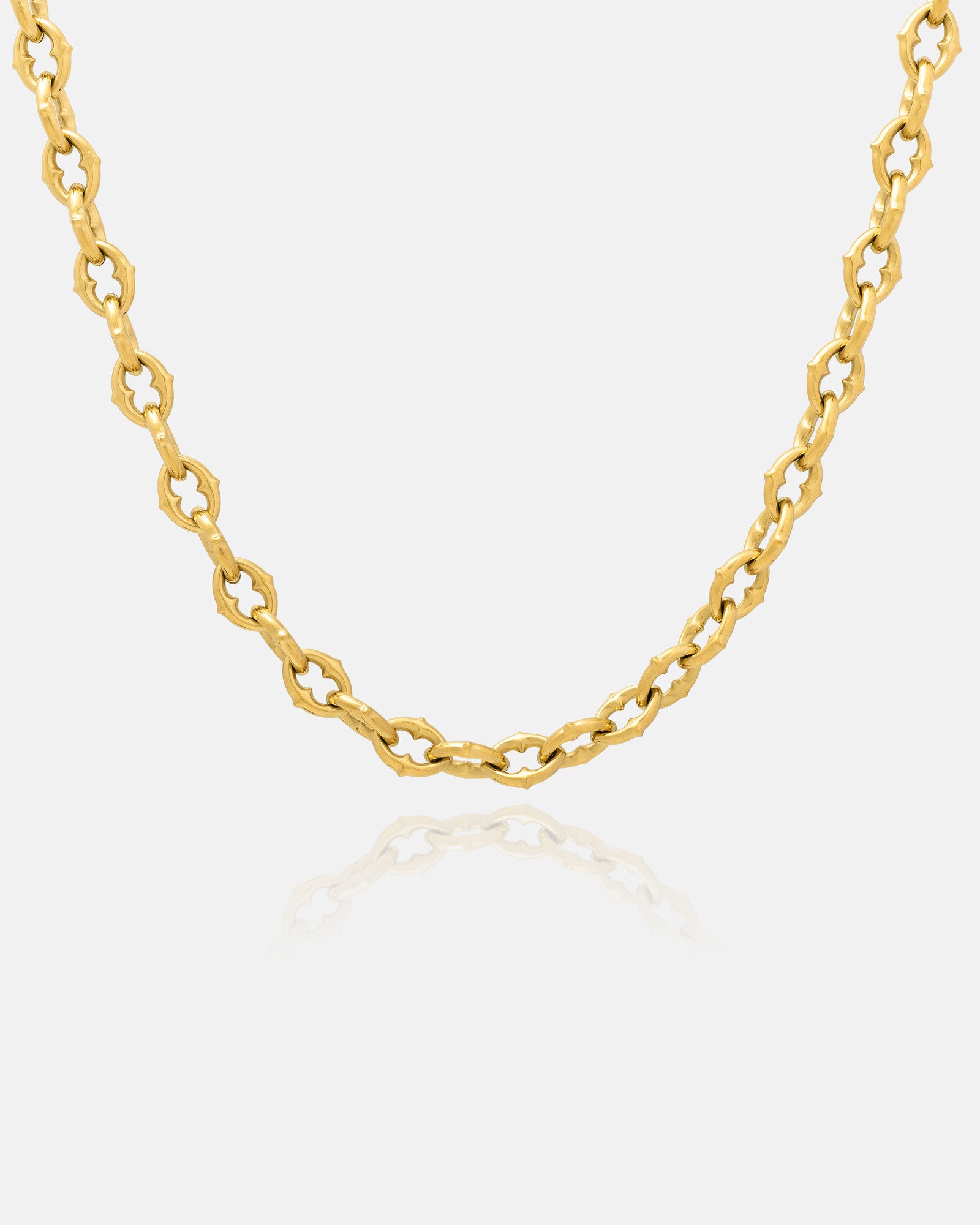 Thick gold spiked chain on white
