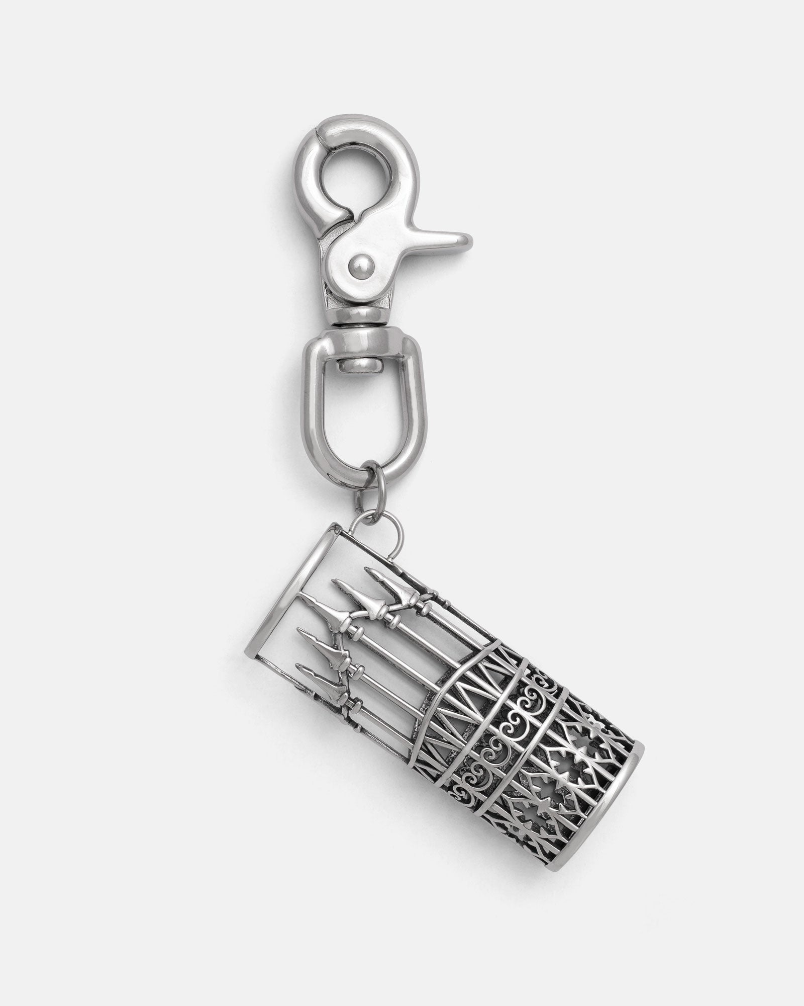 The "Wrought Iron" Lighter Sleeve by Statement Collective is a silver 316L stainless steel keychain with a lobster clasp and a detailed, ornate cylindrical charm inspired by barred cages and spears for lasting durability.
