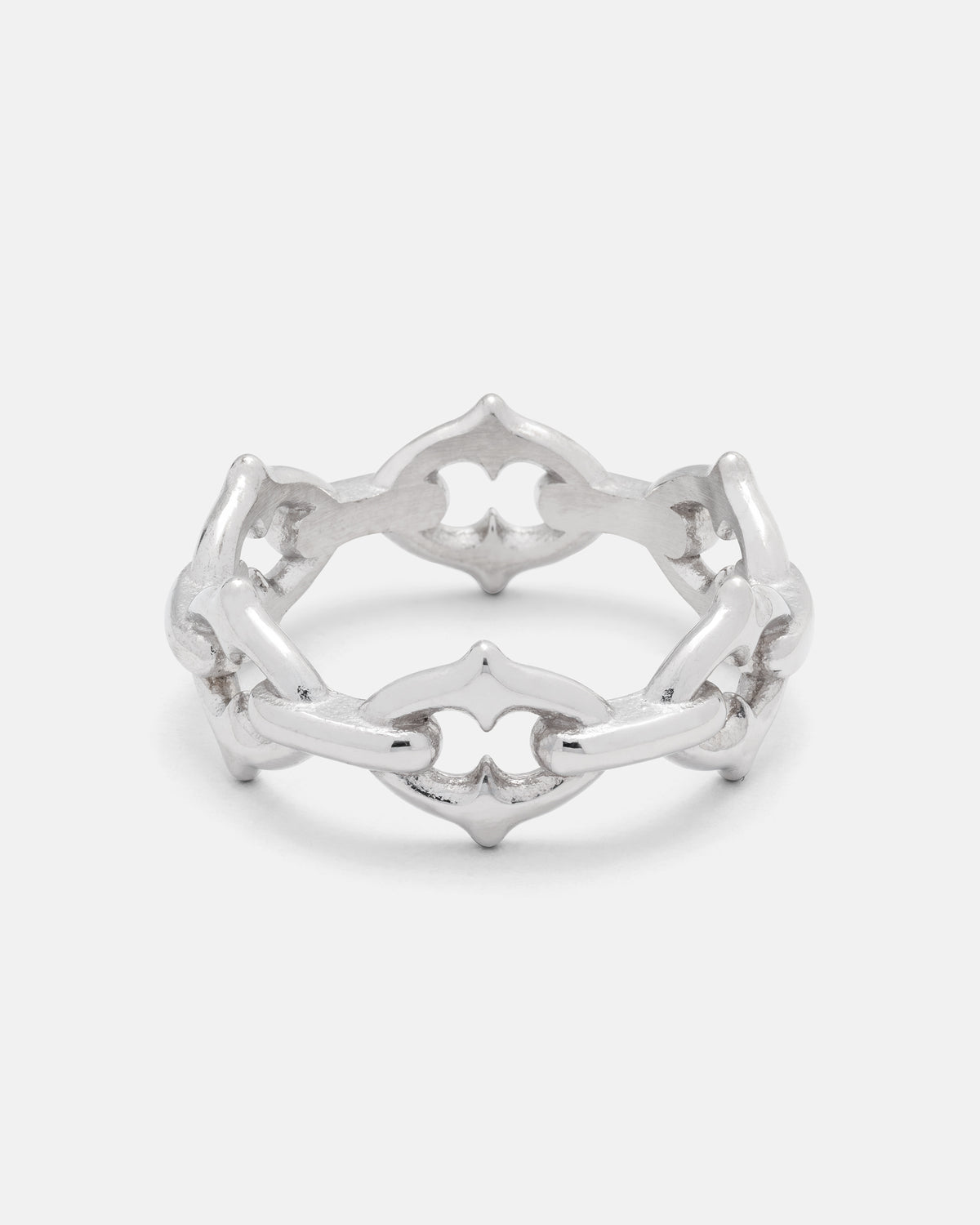 The Cathedral“ Spiked Ring by Statement Collective is a silver gothic chain ring that showcases an openwork pattern of interlocking, ornate shapes, creating a decorative linked design against a plain white background.